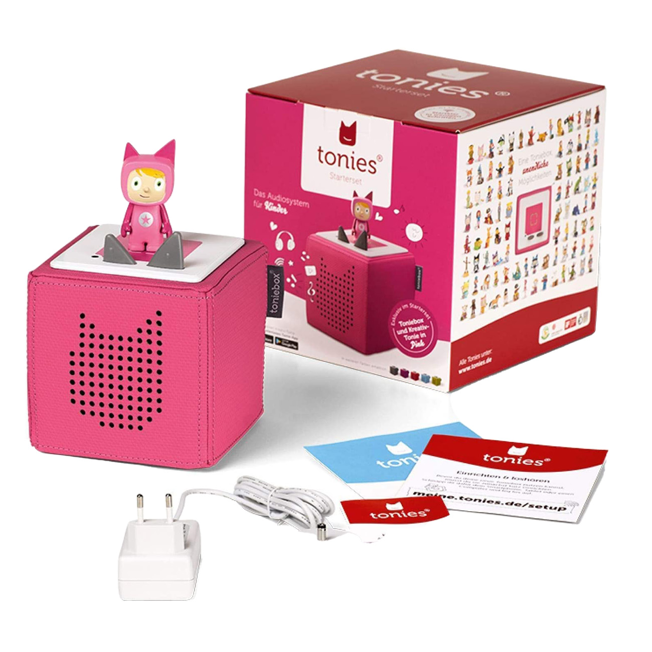 Toniebox rosa con figura, scatola, caricatore e carte su superficie bianca. Tema rosa.