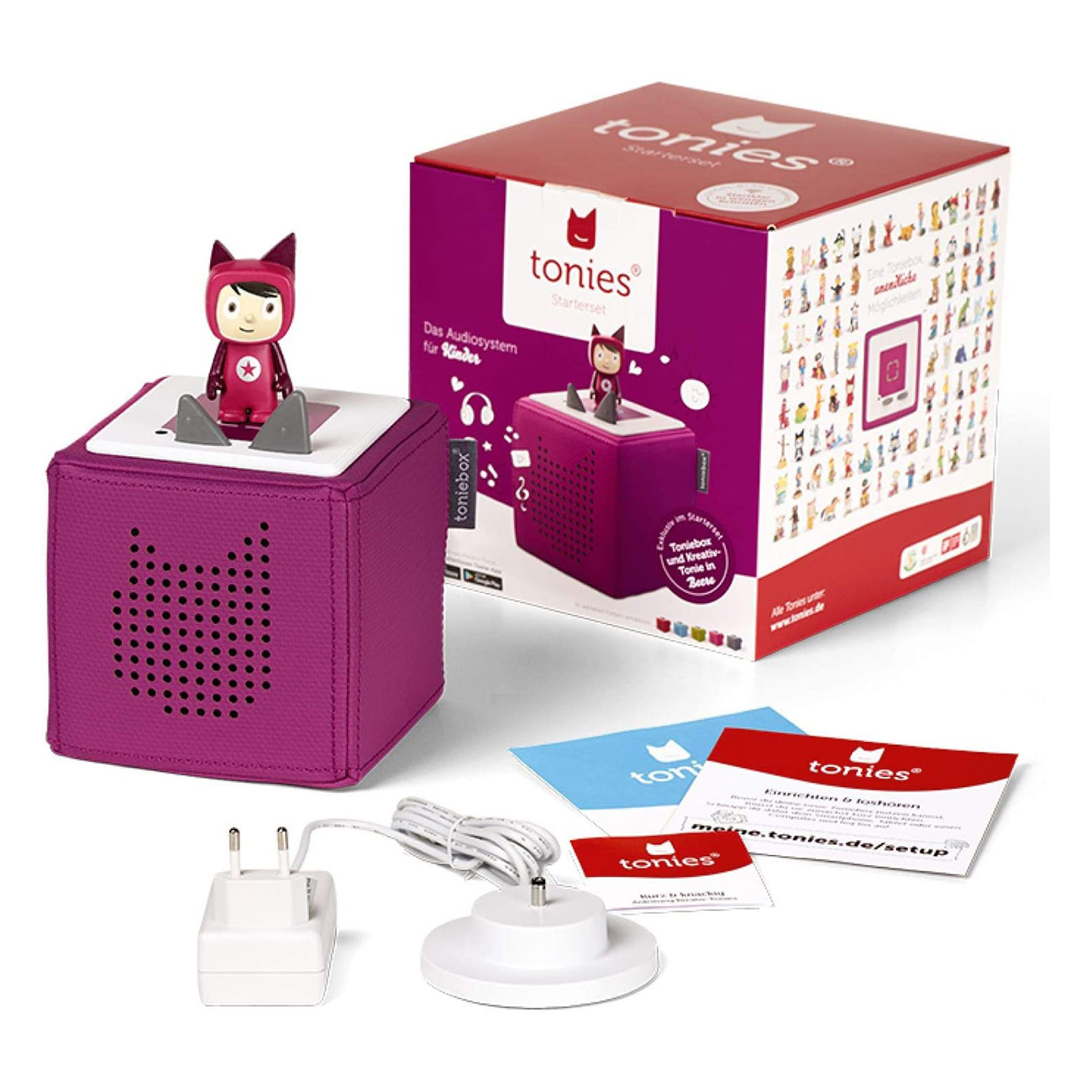 Eine violette Toniebox mit einer Tonie-Figur oben drauf, eine Box und Zubehör. Auf der Box steht 'tonies' und 'starterset'.