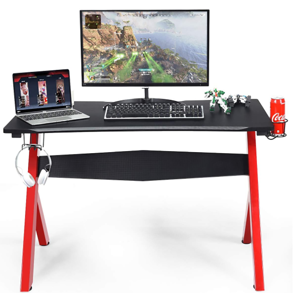 Ein Gaming-Schreibtisch mit Monitor, Laptop und Zubehör. Er hat rote Beine, Kopfhörer und eine Cola-Dose.