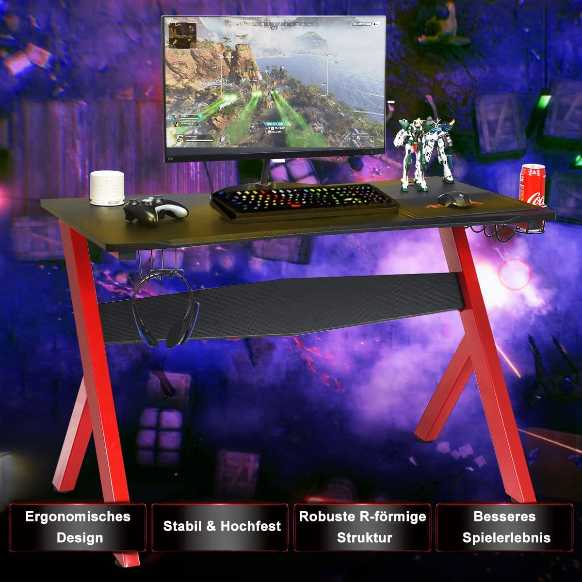 Gaming-Schreibtisch mit roten Beinen und schwarzer Oberseite. Enthält Monitor, Tastatur, Controller.