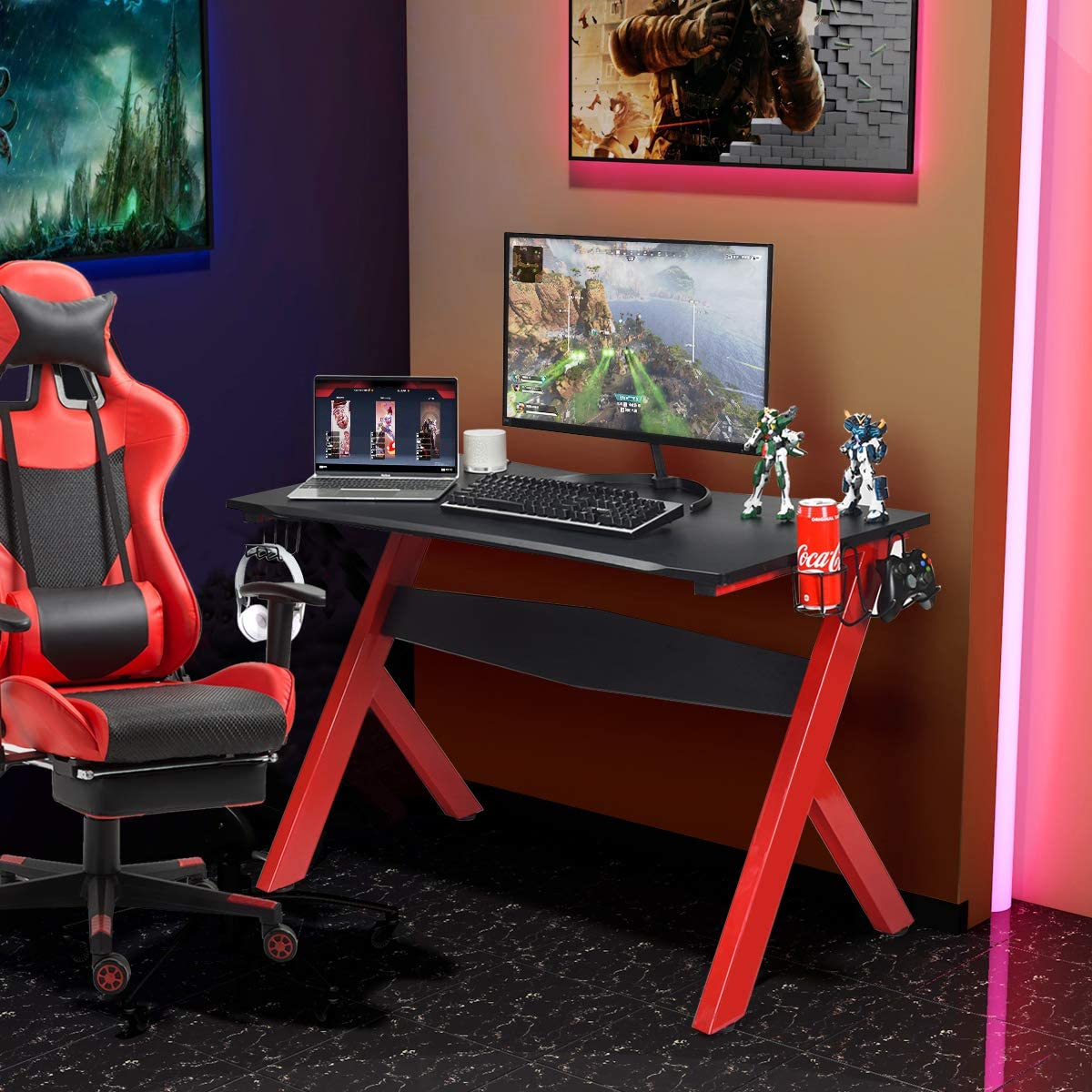 Gaming-Setup: rot-schwarzer Stuhl, schwarzer Schreibtisch mit Laptop, Monitor und Zubehör. Raum mit Lichtern.