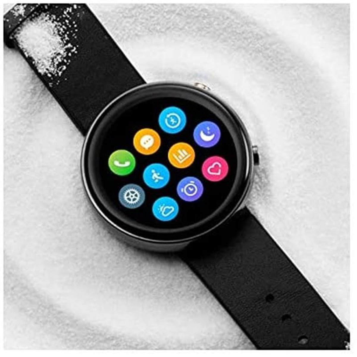 Smartwatch con iconos en la pantalla, correa negra. Muestra una pantalla redonda con múltiples iconos.