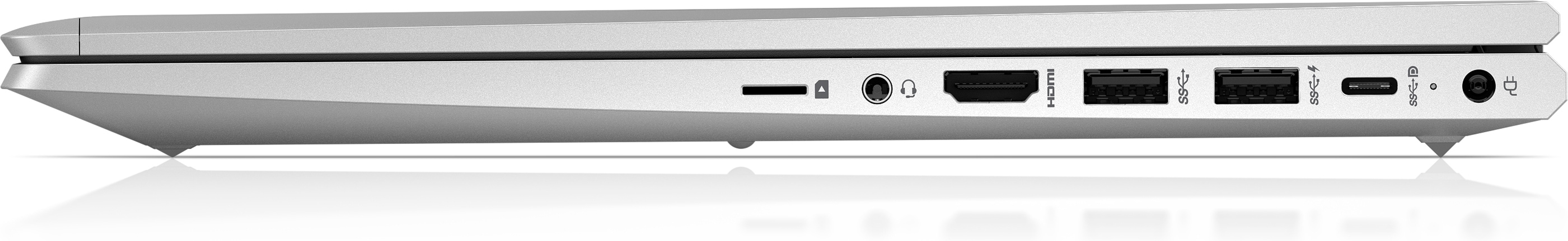 Vista lateral de un portátil plateado con puertos visibles: HDMI, USB y un puerto de carga. Reflexión debajo.