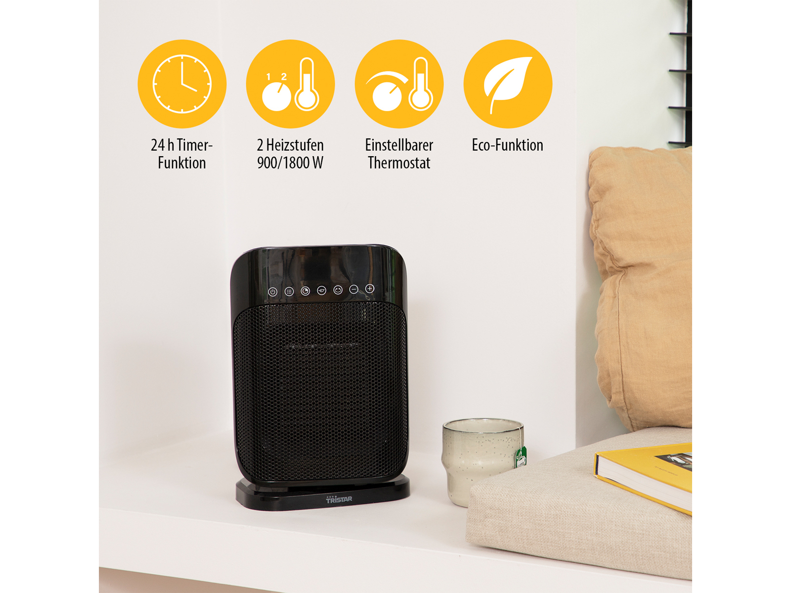 Czarny grzejnik elektryczny na białej półce z ikonami. Filiżanka i książka w pobliżu.