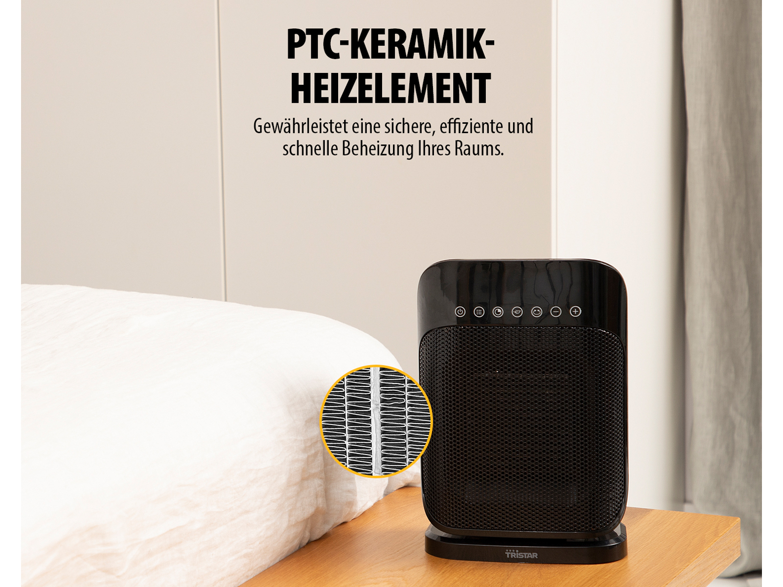 Czarny grzejnik na drewnianym stole obok łóżka z białym kocem, z bliska kratki.