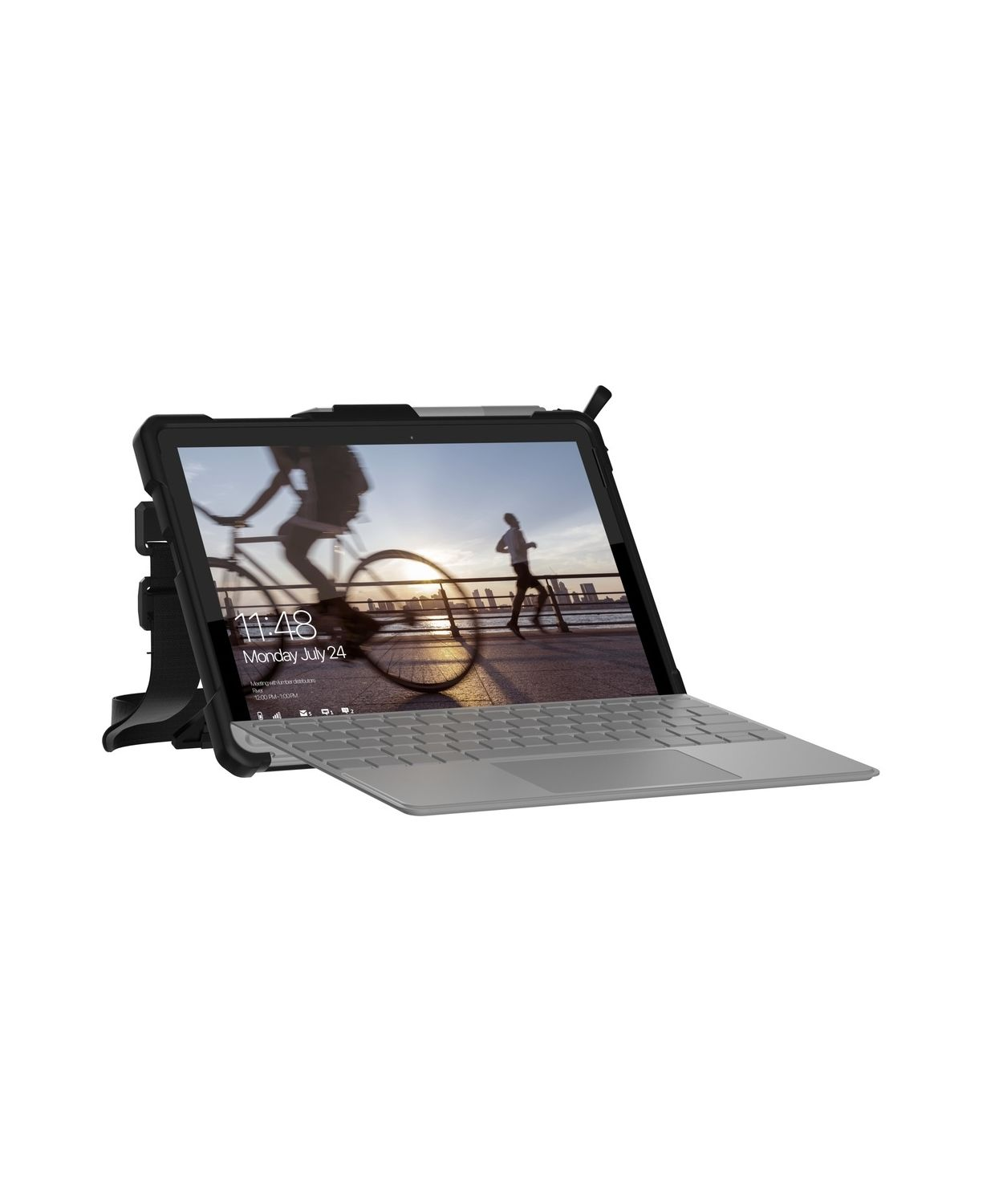 Tablet w etui z wyświetlaczem pokazującym scenę miejską. Podłączona jest klawiatura.