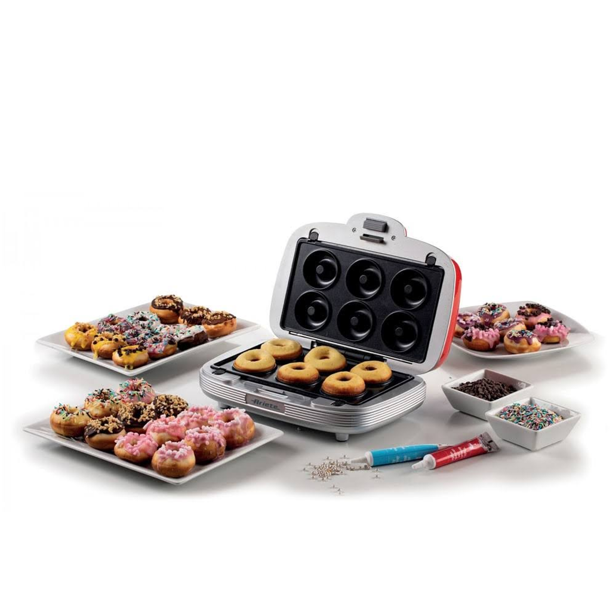 A donut maker with donuts and decorations. The maker is open. White background.