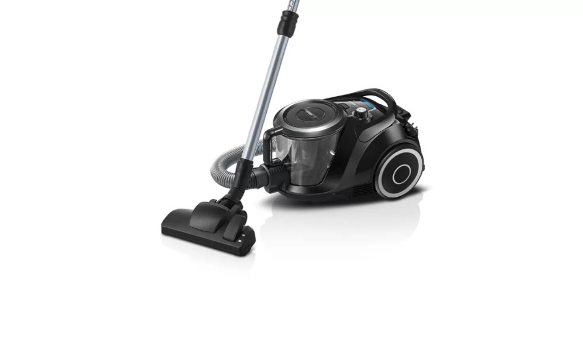 Czarny odkurzacz na białej powierzchni, dysza skierowana w dół, zdjęcie studyjne.
