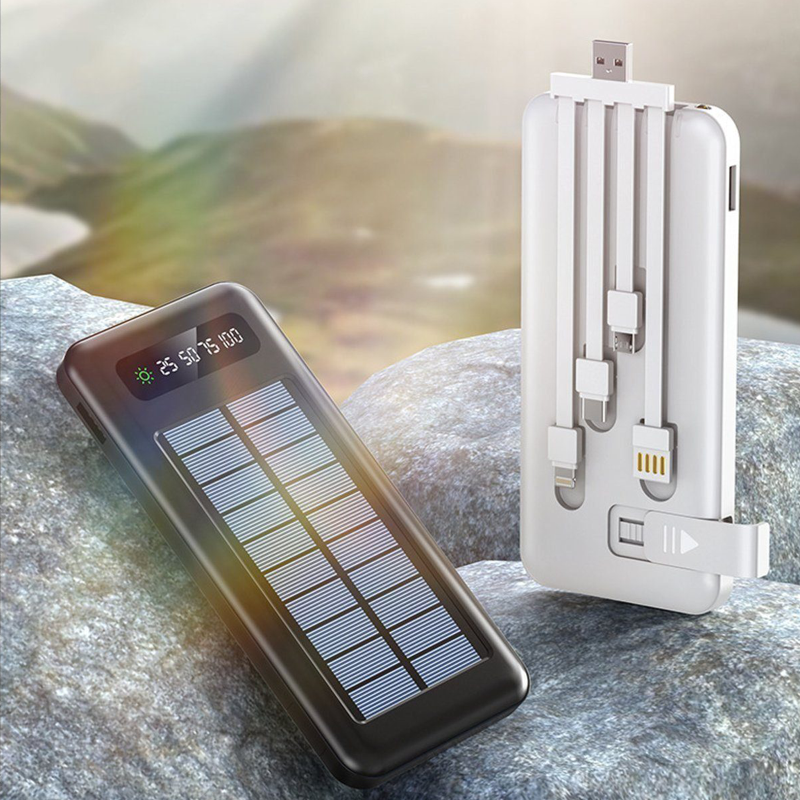 Un cargador solar portátil con pantalla de carga y múltiples cables. El cargador está sobre rocas.