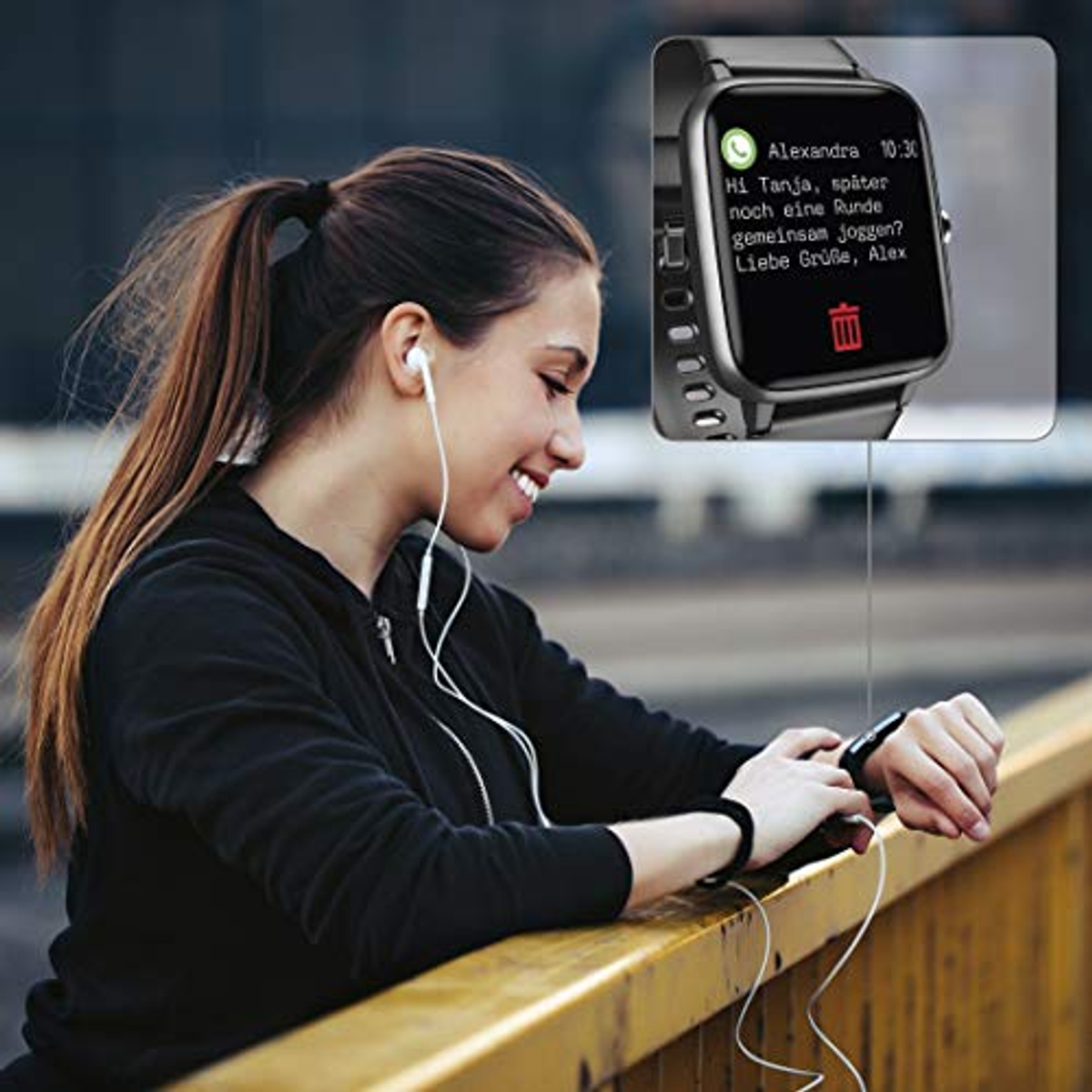 Frau mit Kopfhörern betrachtet Smartwatch mit Nachricht.