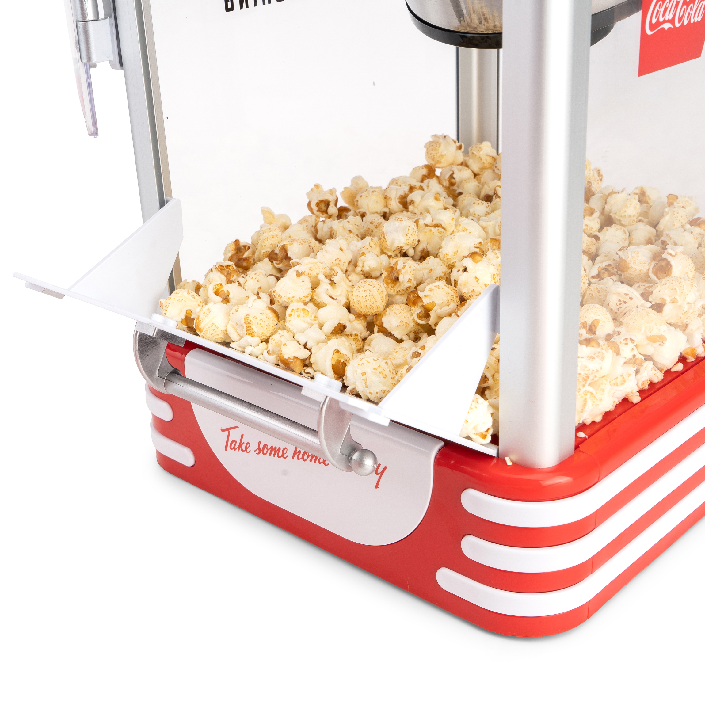Popcornmaschine, Popcorn quillt in ein Tablett über.