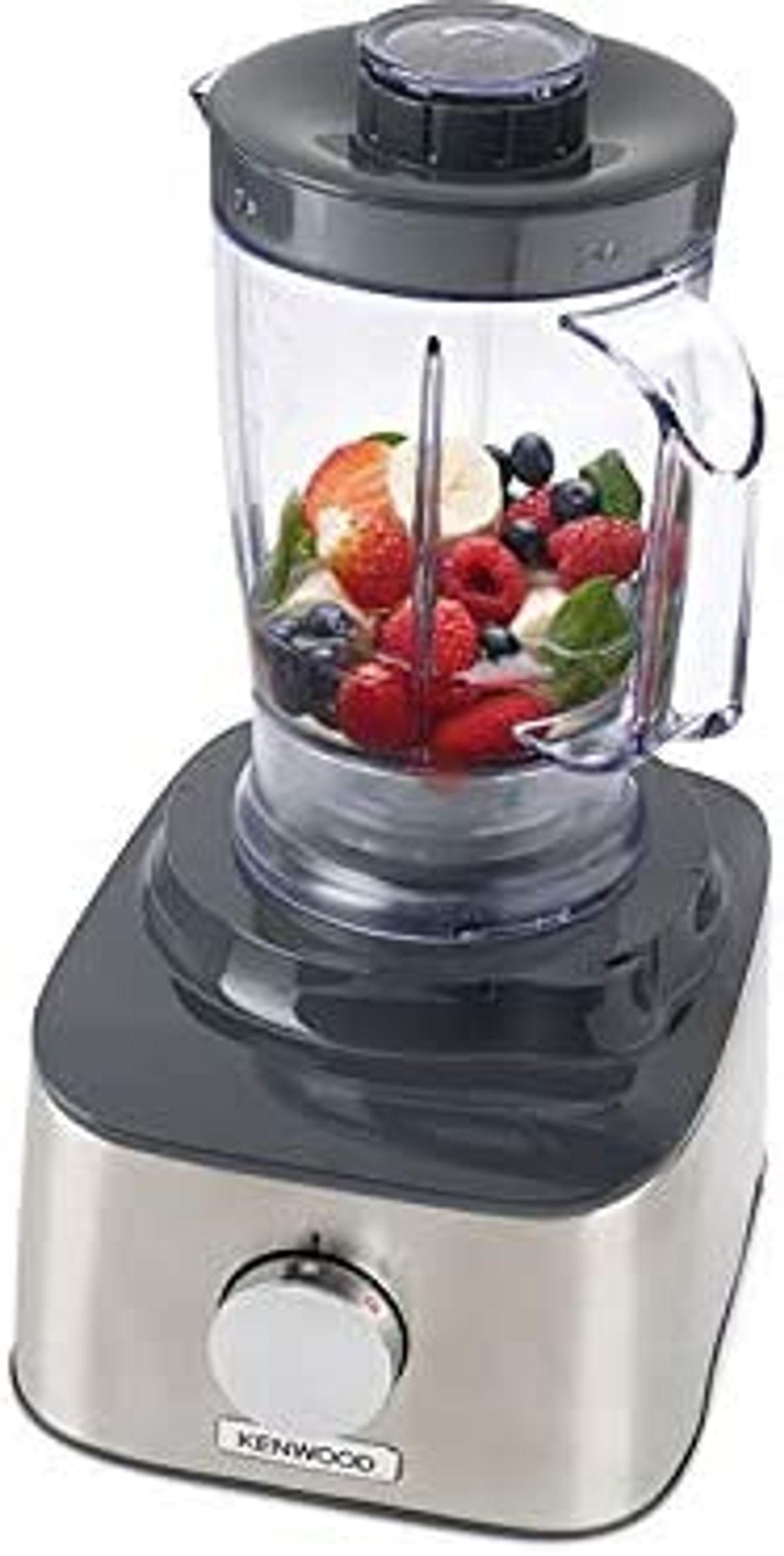 Licuadora con ingredientes dentro. Las frutas son visibles en el recipiente transparente.