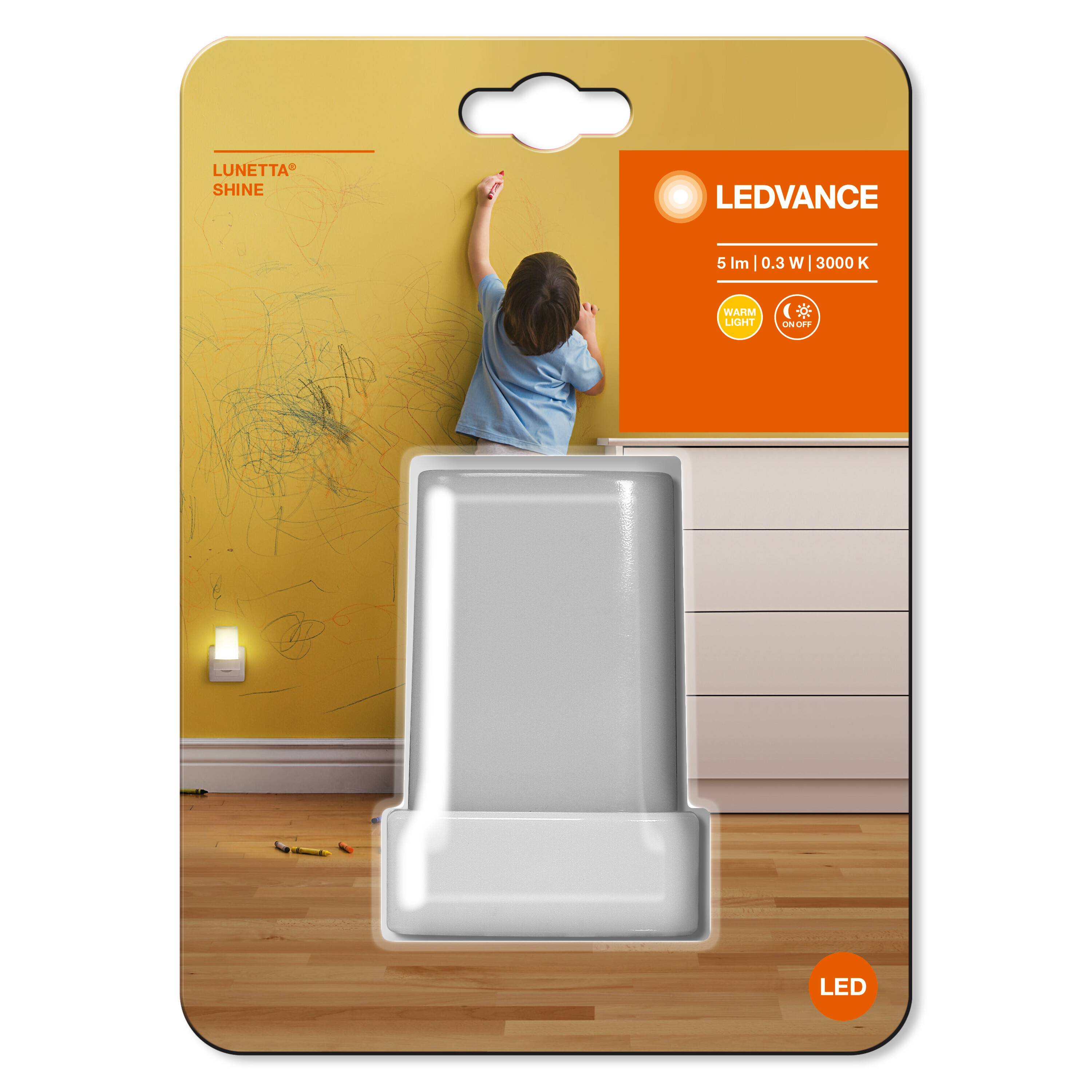 Confezione di luce notturna. Un bambino disegna su un muro. La luce è bianca.
