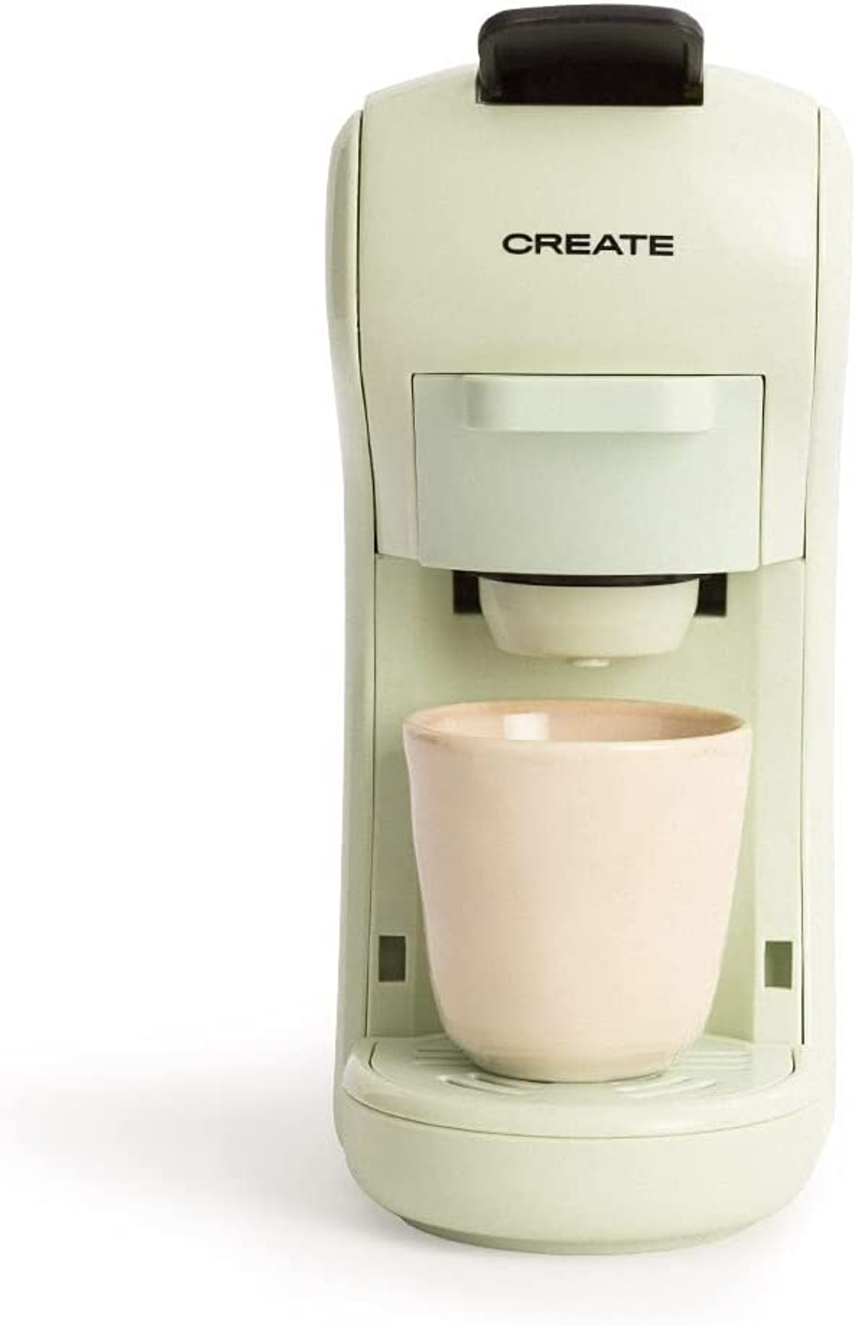 Cafetera verde y blanca con una taza rosa. CREATE está en la parte superior.