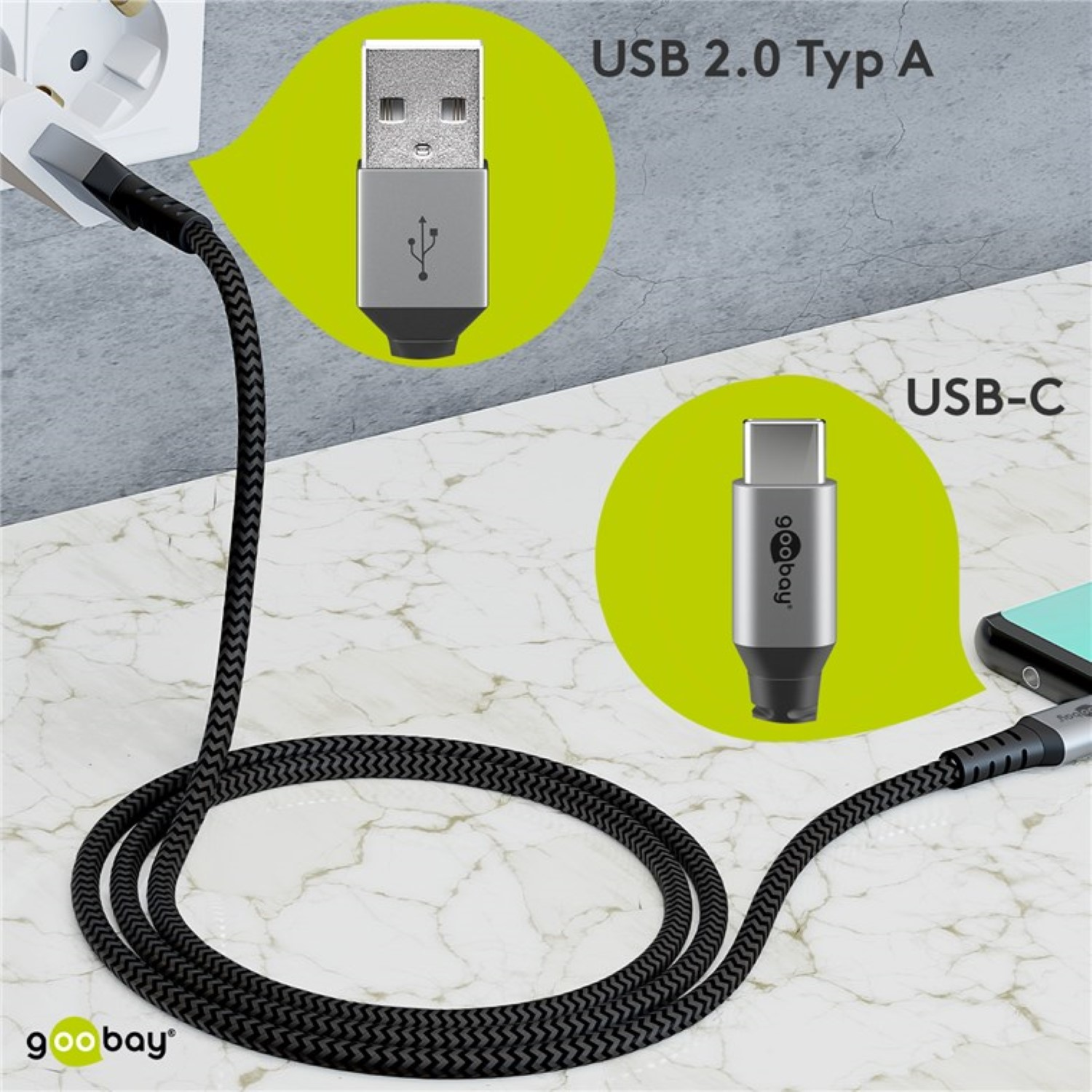 Câble USB avec connecteurs USB 2.0 et USB-C, avec bulles vertes, sur une surface en marbre.
