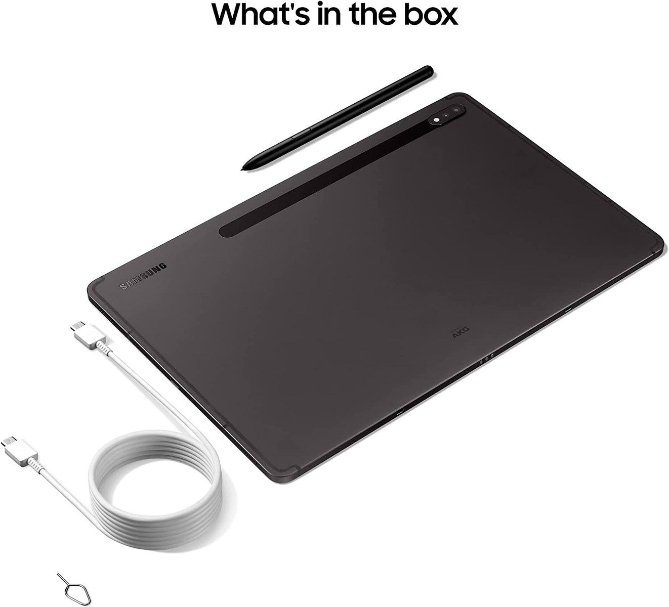 Tableta, lápiz y accesorios en una caja. Tableta oscura, cable blanco y eyector de tarjeta SIM.