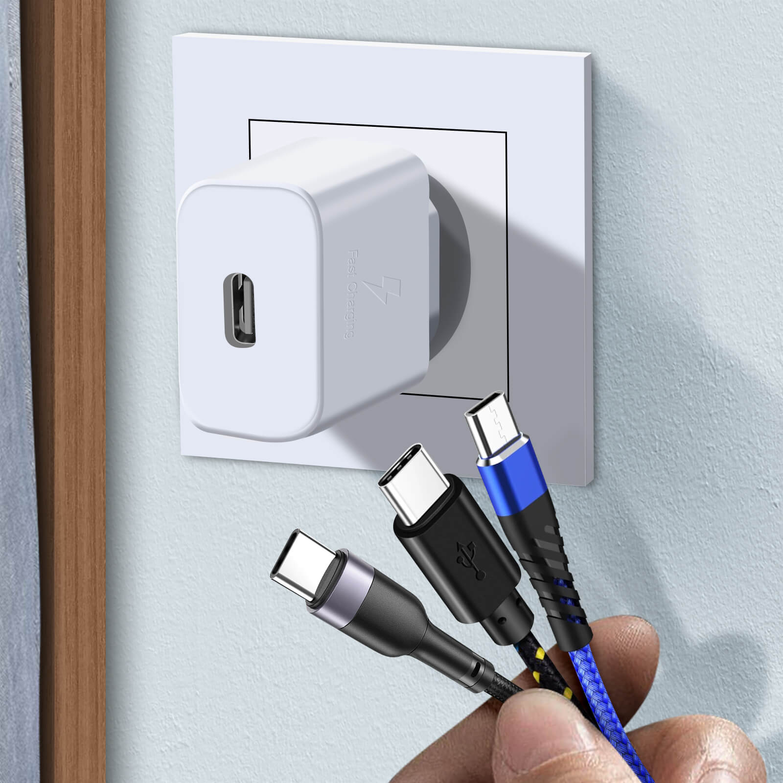 Chargeur branché au mur avec trois câbles, sur fond bleu clair.