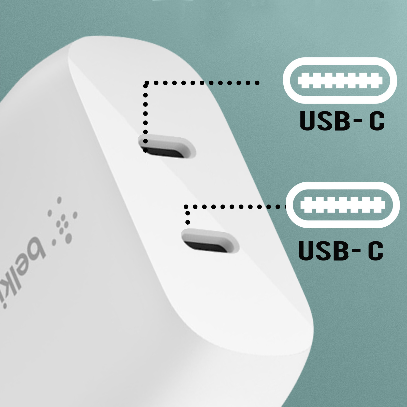 Beyaz Belkin şarj cihazı, iki USB-C bağlantı noktası, bağlantı noktalarına işaret eden noktalı çizgilerle, yeşil bir yüzey üzerinde.