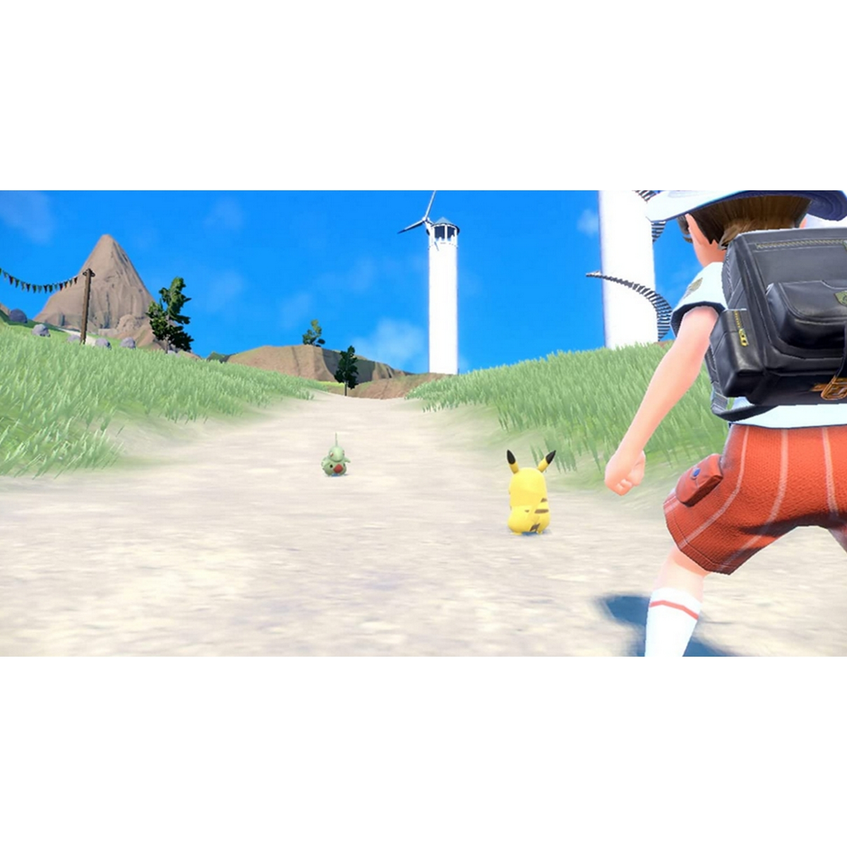 Osoba idzie polną ścieżką w kierunku dwóch postaci Pokemon. Biała wieża w tle.