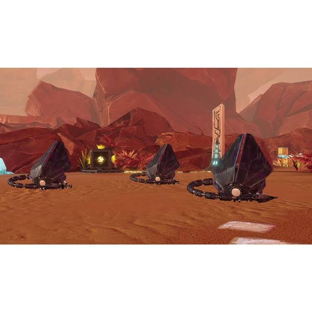 Escena de juego en un planeta rojo. Tres estructuras negras con anillos. Formaciones rocosas rojas al fondo.