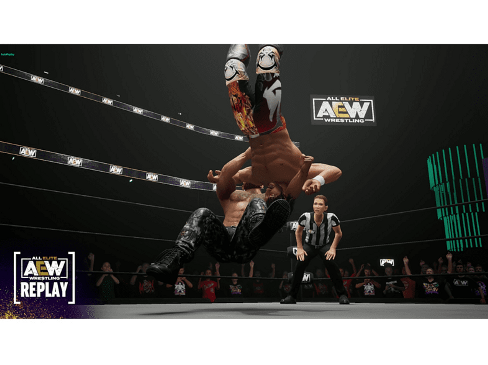 Dwóch zapaśników na ringu. Jeden jest do góry nogami, a przeciwnik go trzyma. Sędzia obserwuje.