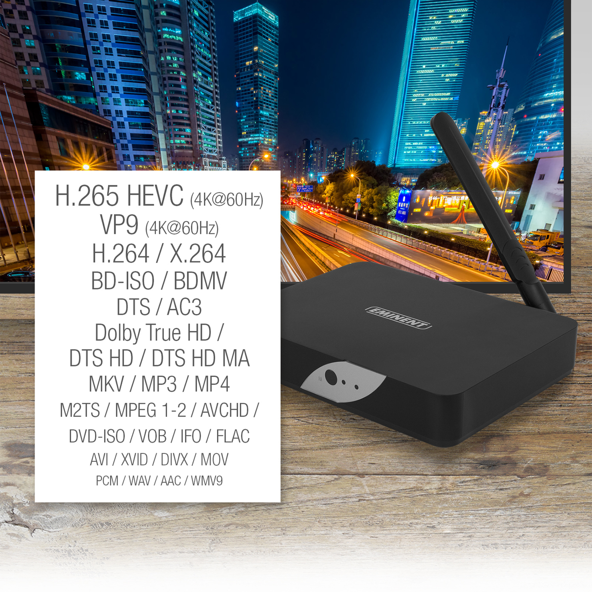 Dispositivo reproductor multimedia negro con texto que enumera formatos de video y audio, y un horizonte urbano en el fondo.