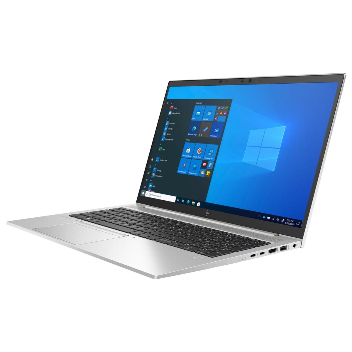 Portátil plateado sobre fondo blanco. La pantalla muestra el menú de inicio de Windows con iconos de aplicaciones.