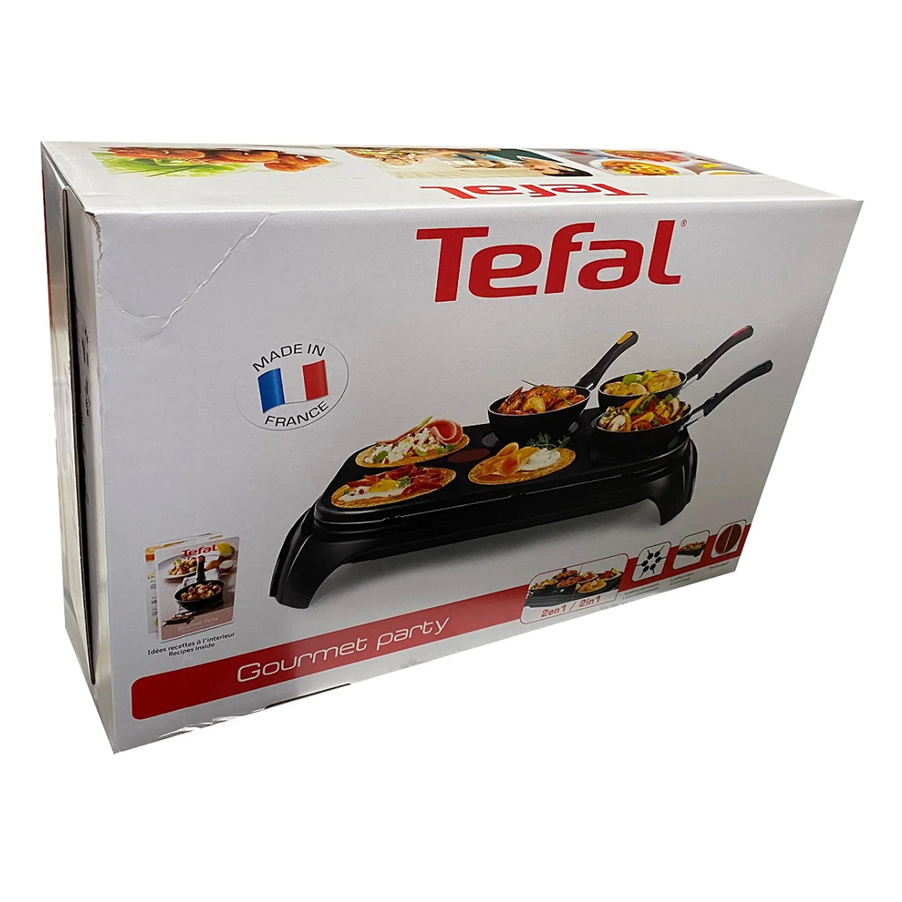 Tefal Gourmet Party Box. Enthält einen Raclette-Grill mit kleinen Pfannen und Essen darin.
