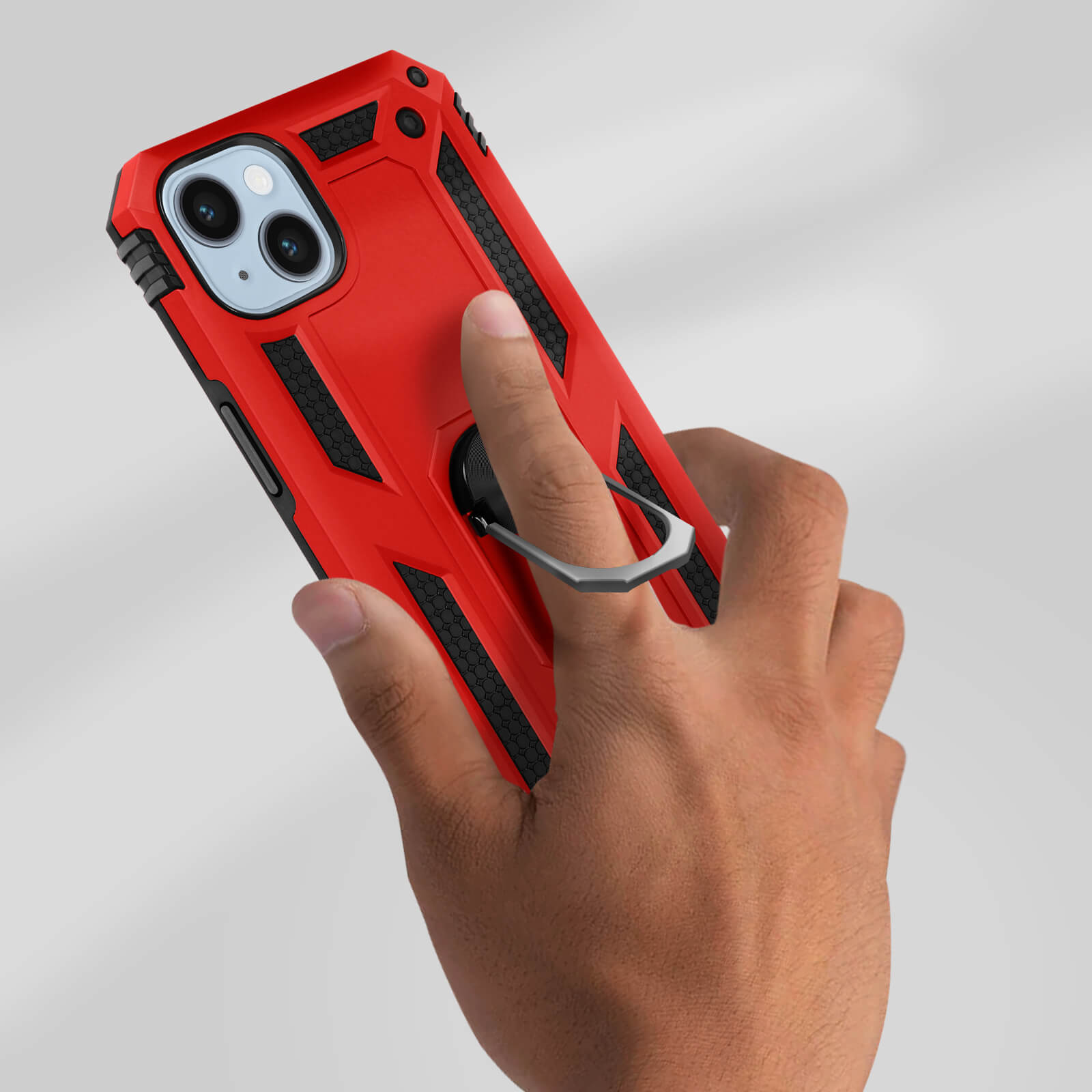 Une main tenant un étui de téléphone rouge avec une bague à l'arrière. L'étui a des accents noirs.
