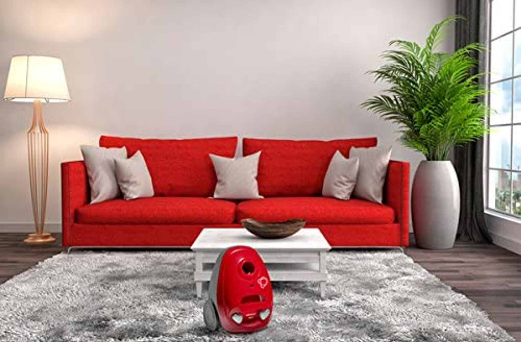 Czerwona sofa z poduszkami, lampa, stolik kawowy z odkurzaczem i rośliną w salonie.