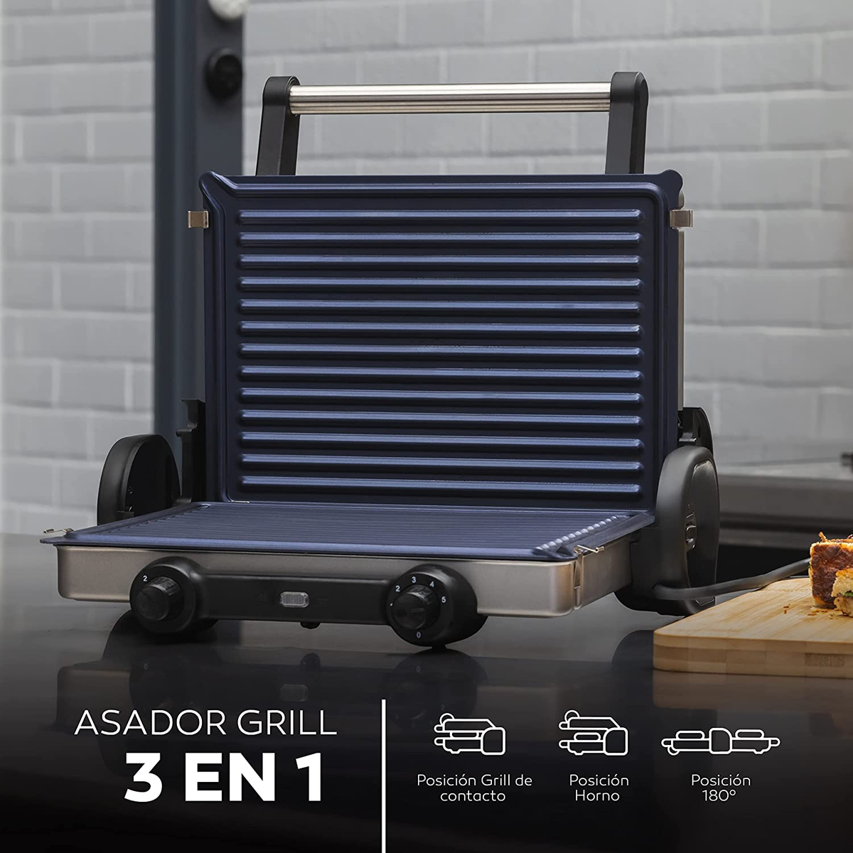 Parrilla azul y plateada abierta con el texto "ASADOR GRILL 3 EN 1". Fondo blanco.