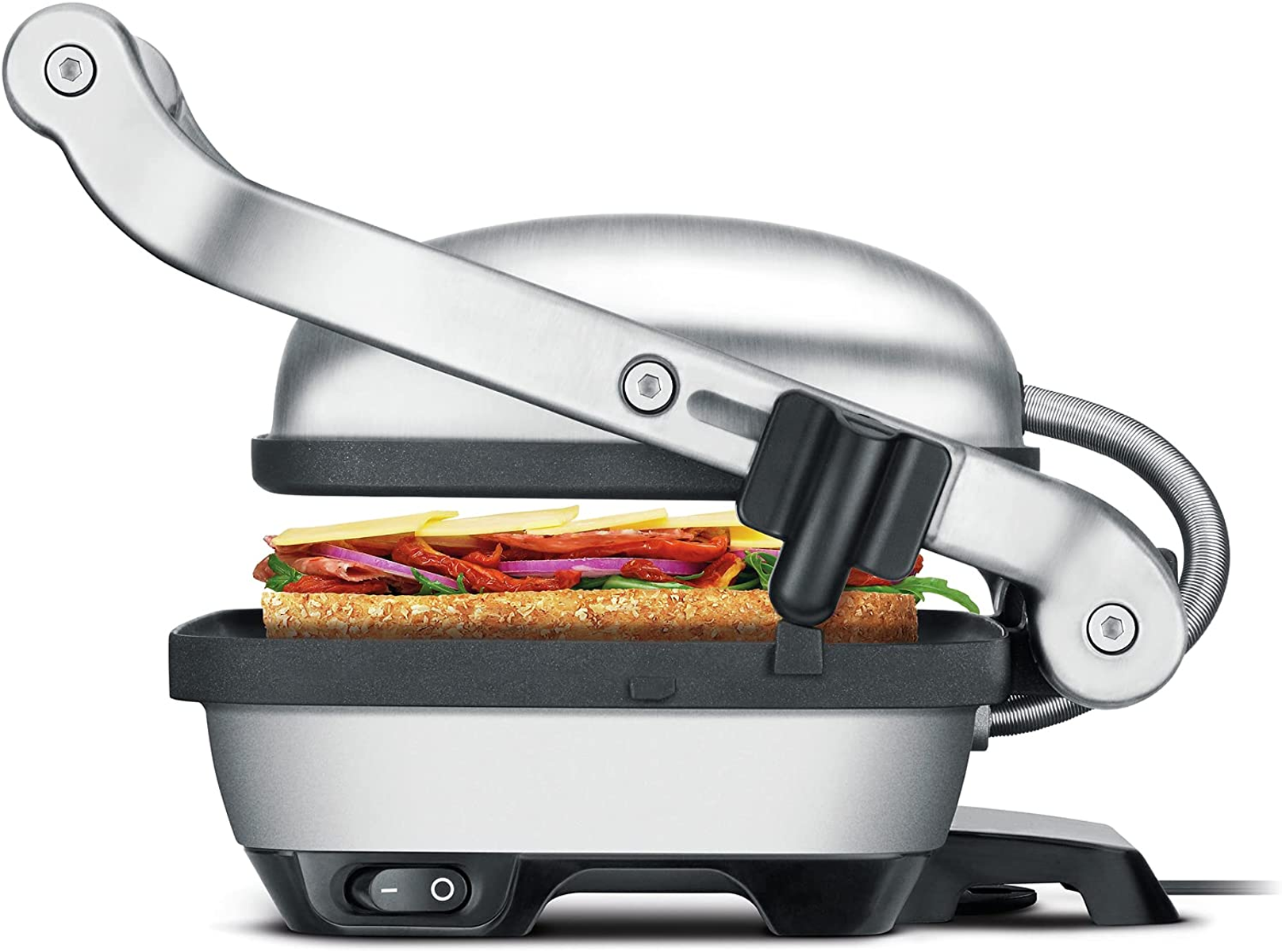 Sandwichmaker mit Sandwich, Gemüse und Käse. Silbernes Gerät.