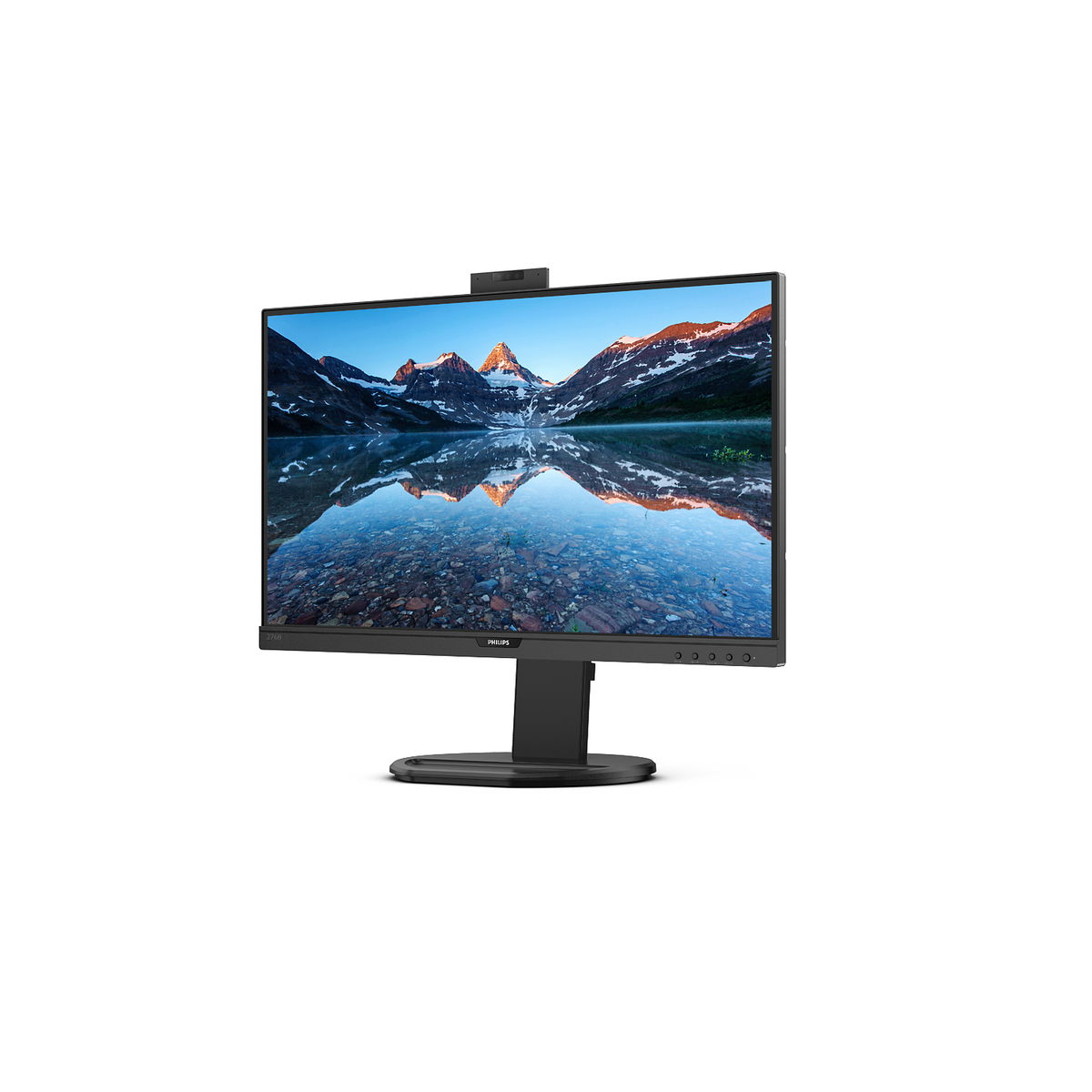 Monitor de computadora con una cámara web en la parte superior, mostrando un paisaje con montañas y un lago.