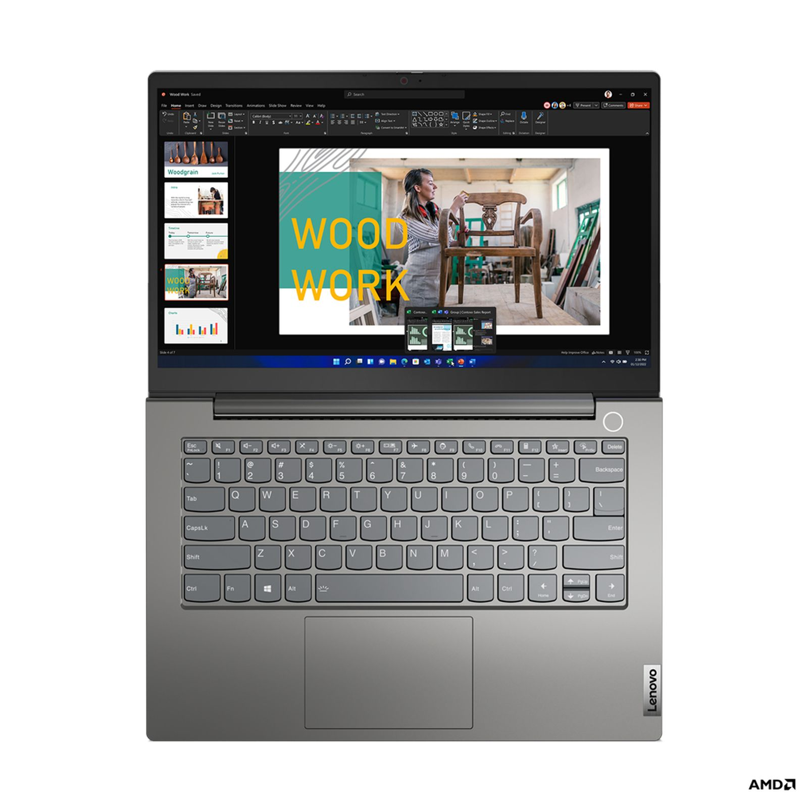 Laptop mit einer "WOOD WORK"-Präsentation auf dem Bildschirm, silberner Tastatur und schwarzem Rahmen.