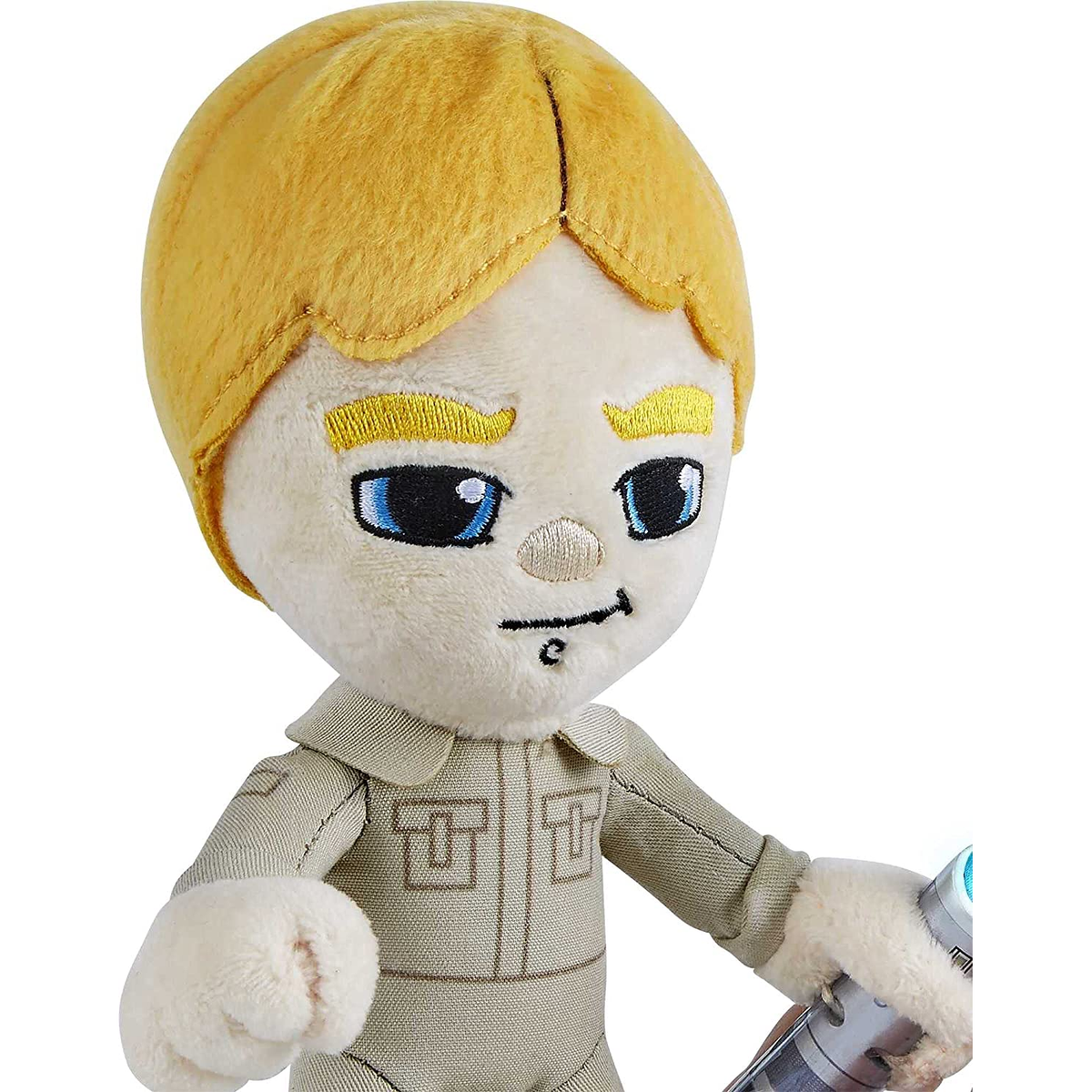 Juguete de peluche de Luke Skywalker con cabeza rubia, ojos azules y un sable láser.