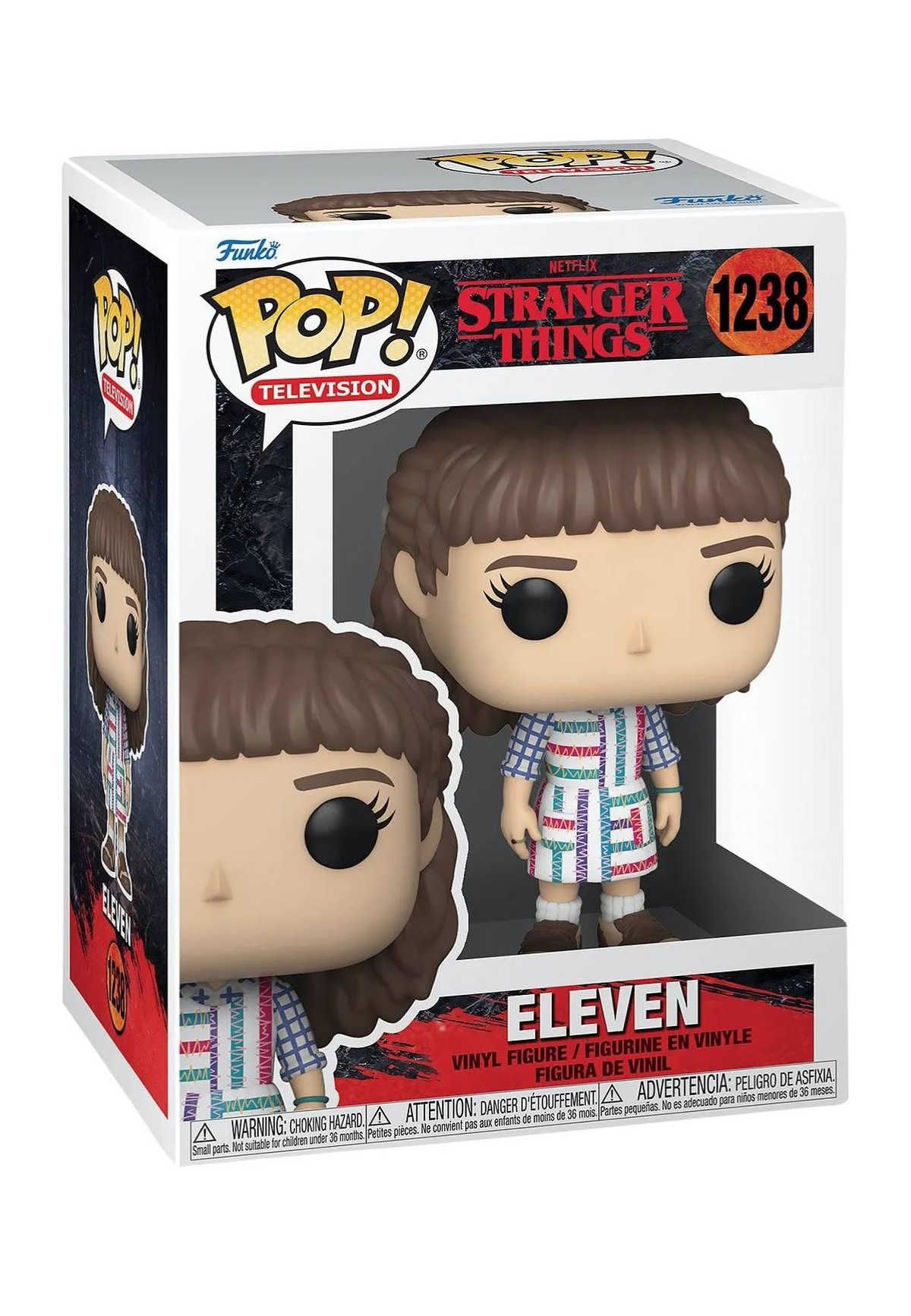 Figura di Eleven in una scatola. Indossa un vestito colorato. La scatola ha 'Stranger Things' e 'Funko Pop'.