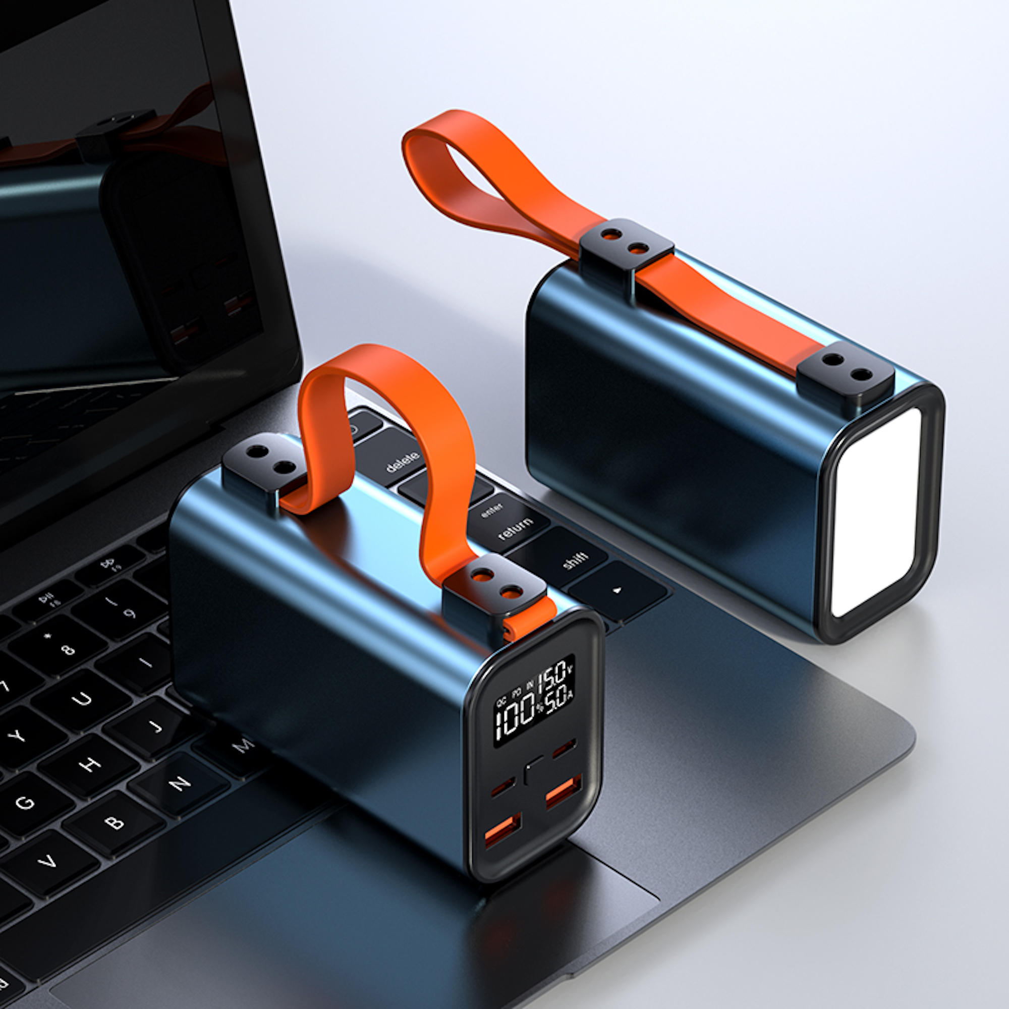 Due power bank portatili blu e arancioni su una tastiera di un laptop. Hanno manici arancioni e schermi.