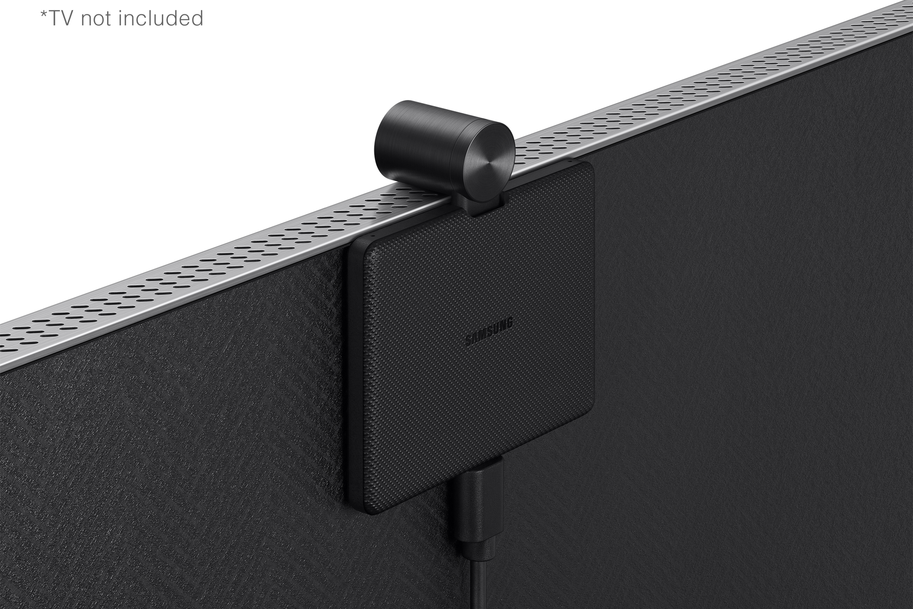 Un dispositivo Samsung negro adjunto a un televisor. Tiene una cámara y una caja.