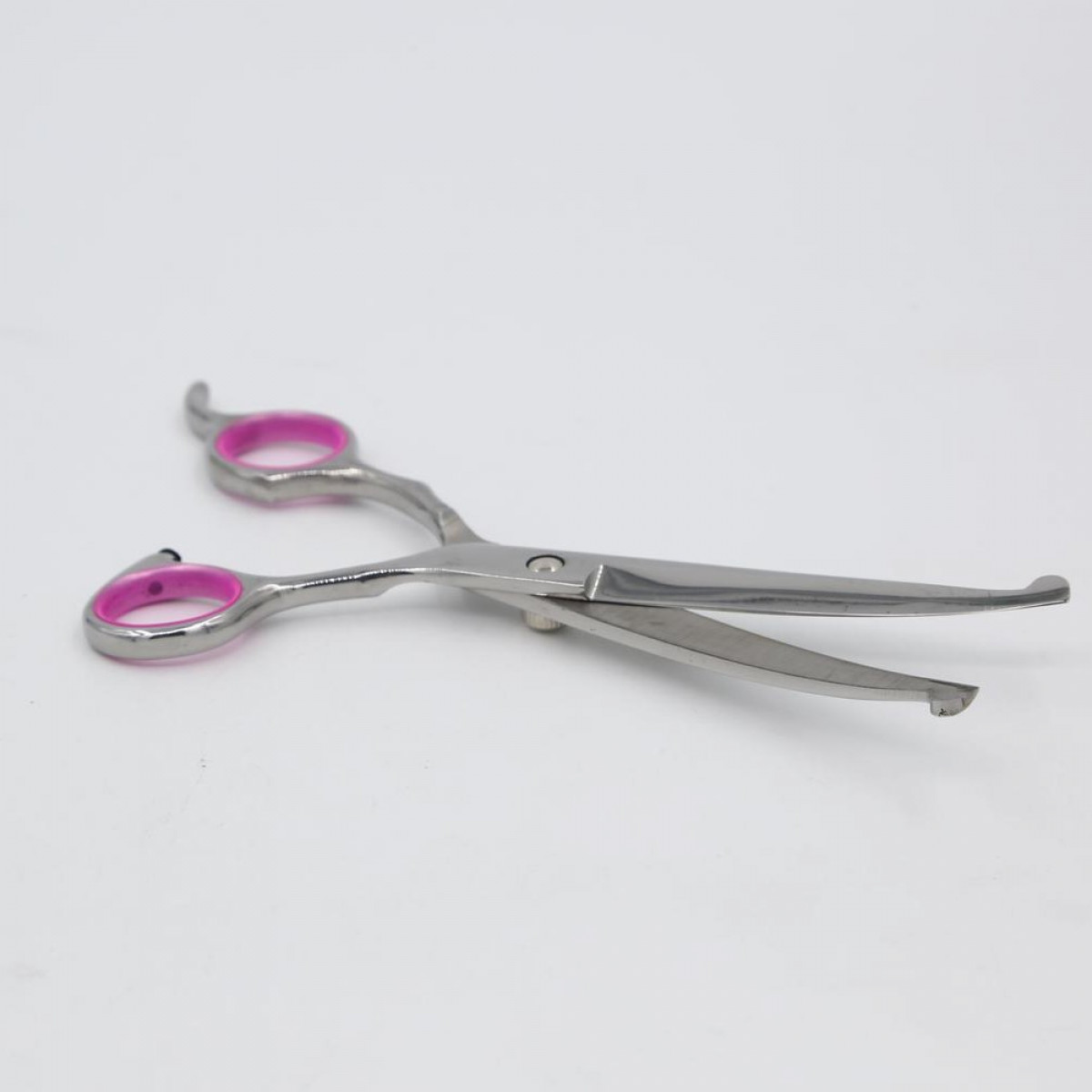 Scissors with pink finger holes. They are on a white background.