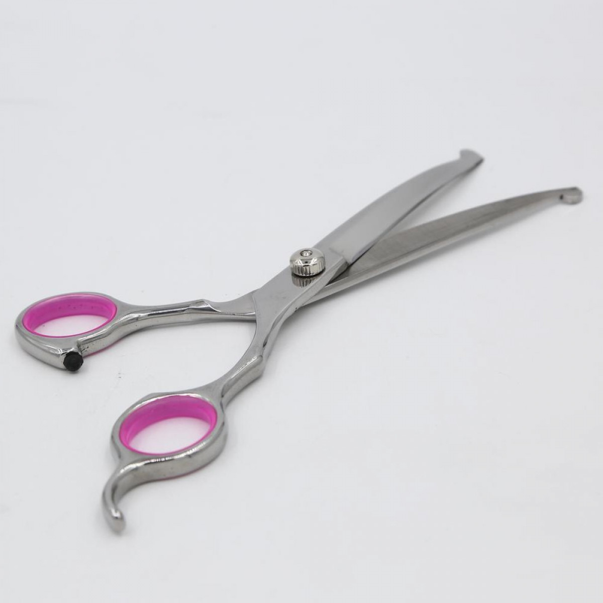 Silver scissors with pink handle inserts, on a white surface.