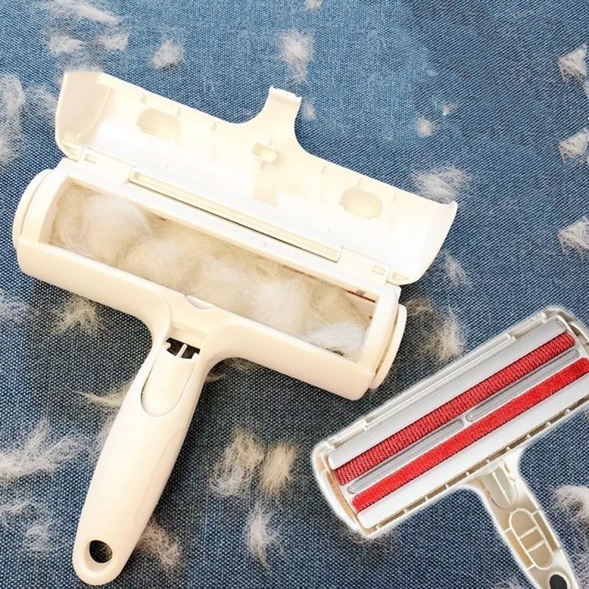 Weißer Tierhaarentferner mit offenem Deckel, roter Rollbürste und verstreuten Haaren.