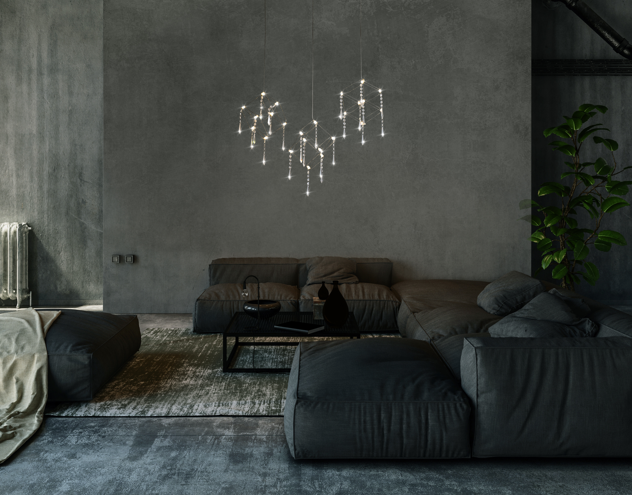 Ein modernes Wohnzimmer mit dunkelgrauen Wänden, einem grauen Sofa und einem Kronleuchter mit mehreren Lichtern.