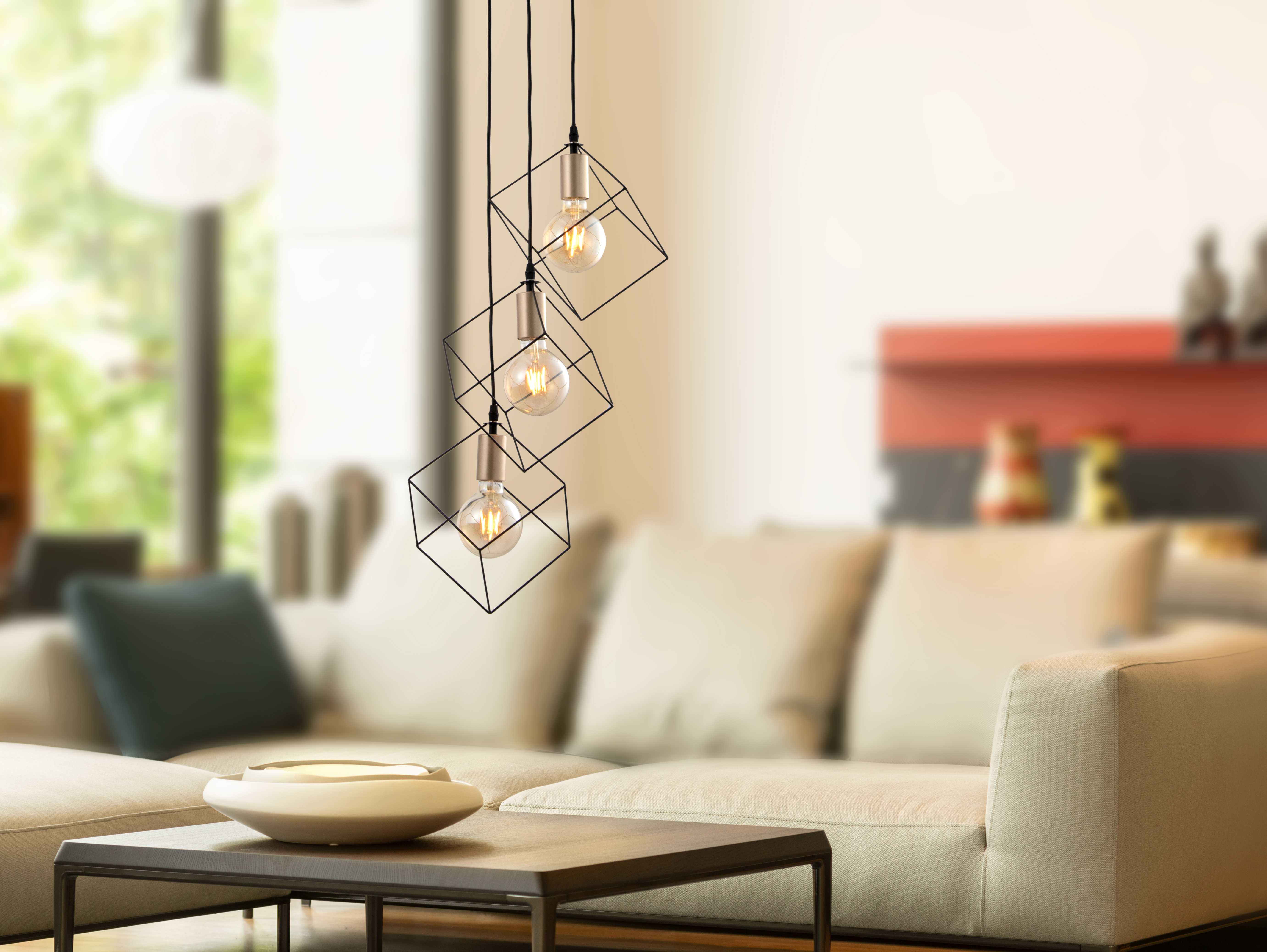 Drei Hängeleuchten mit geometrischen Schirmen. Lichter über Tisch und Couch.