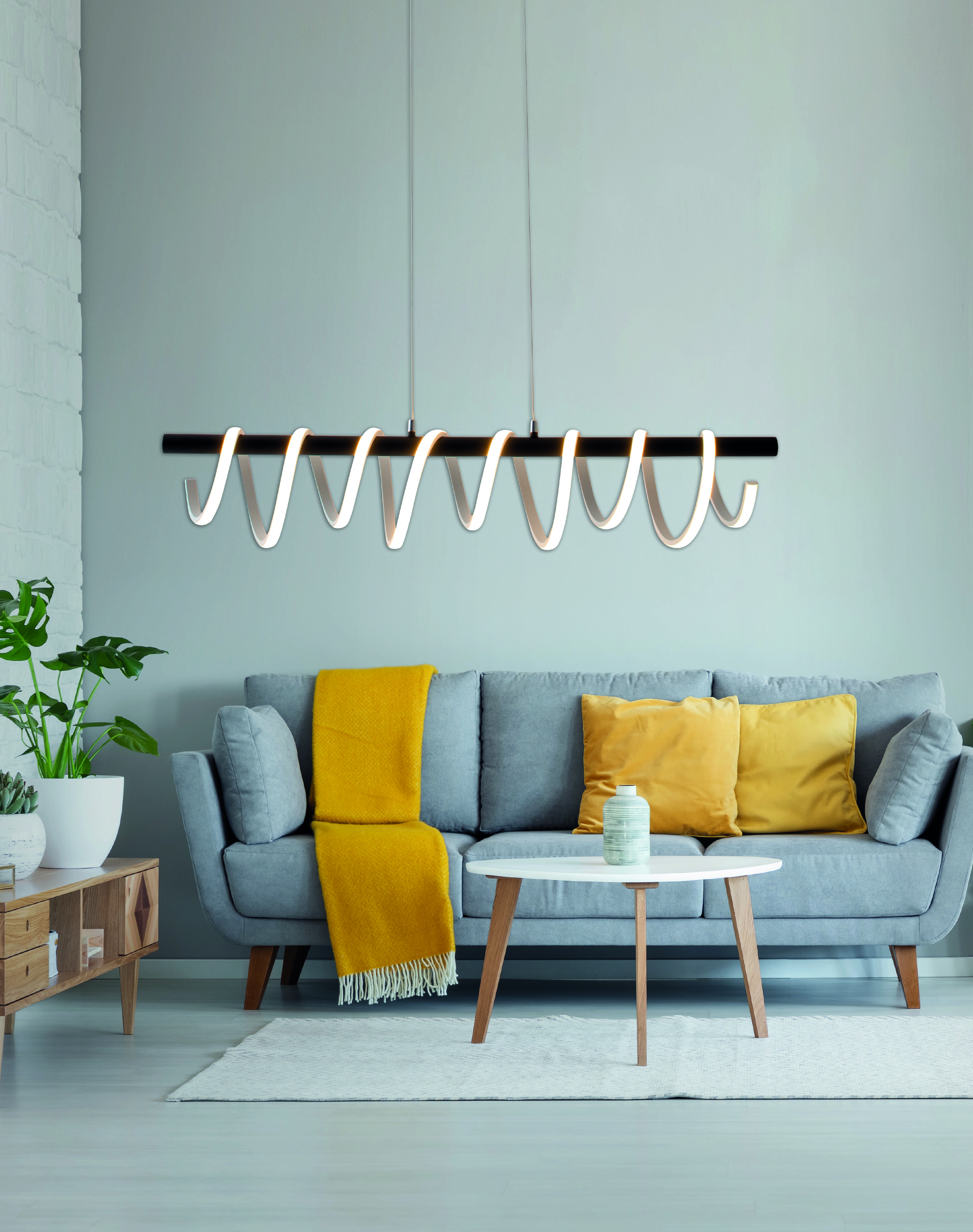 Modernes Wohnzimmer. Sofa, gelbe Decke und Kissen, runder Tisch.