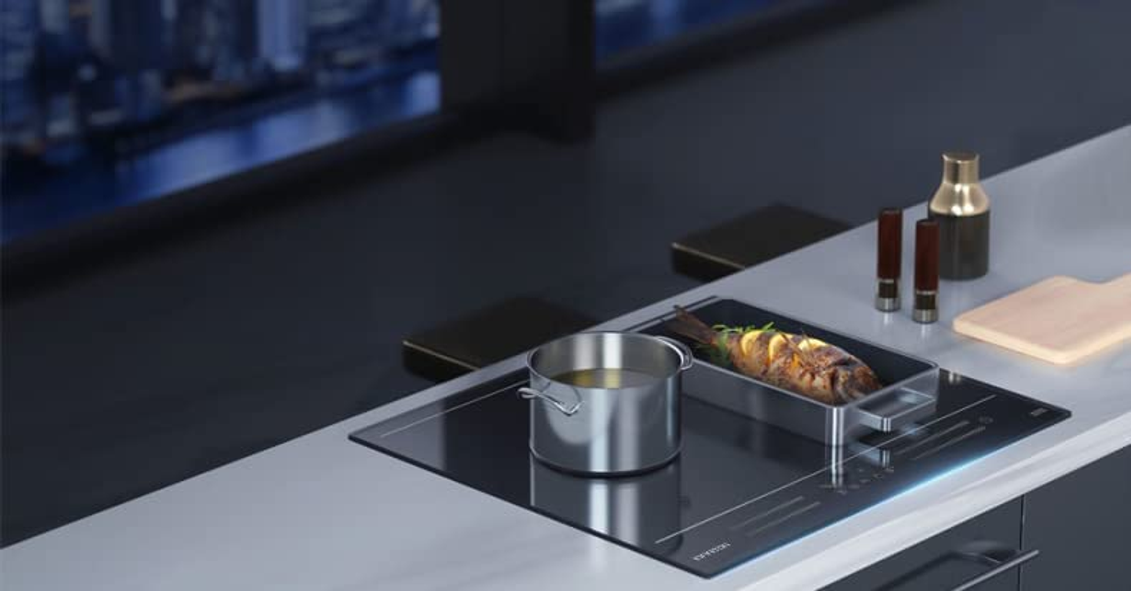 Una cocina moderna con una estufa y una sartén con comida.
