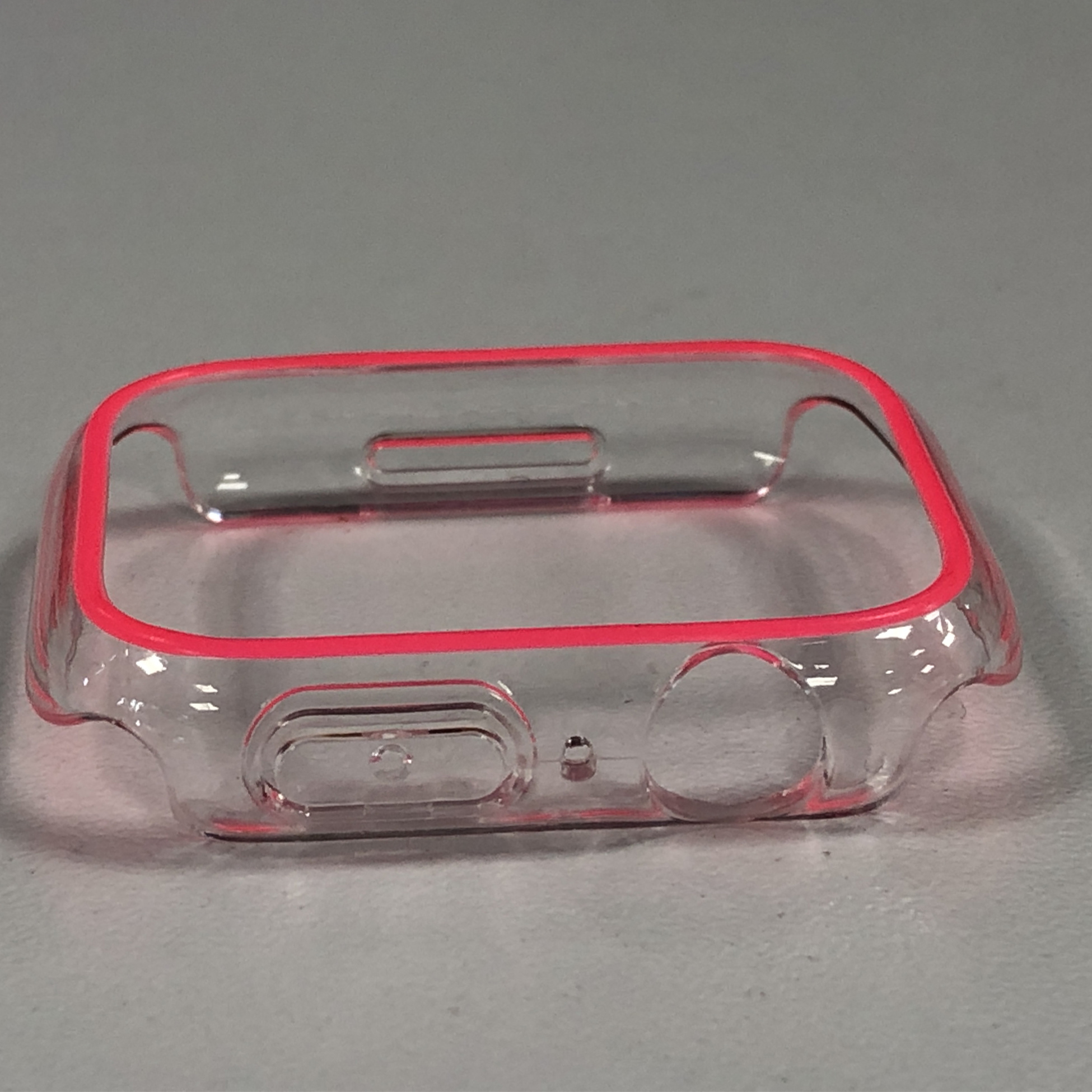 Klares Uhrengehäuse mit pinkfarbenem Rand. Es hat Aussparungen für die Uhr.