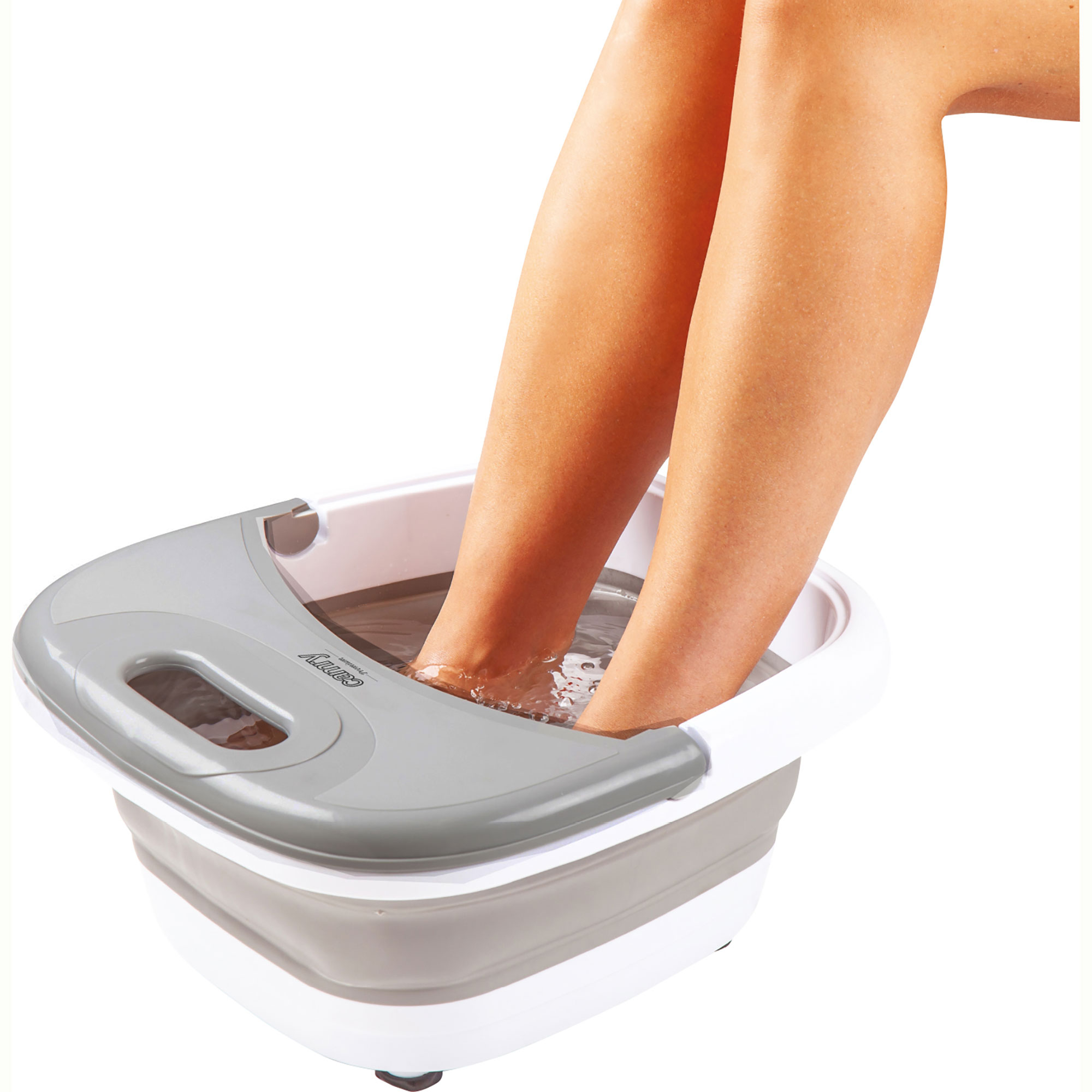 Piedi immersi in una vasca idromassaggio bianca e grigia, con acqua e gambe visibili.