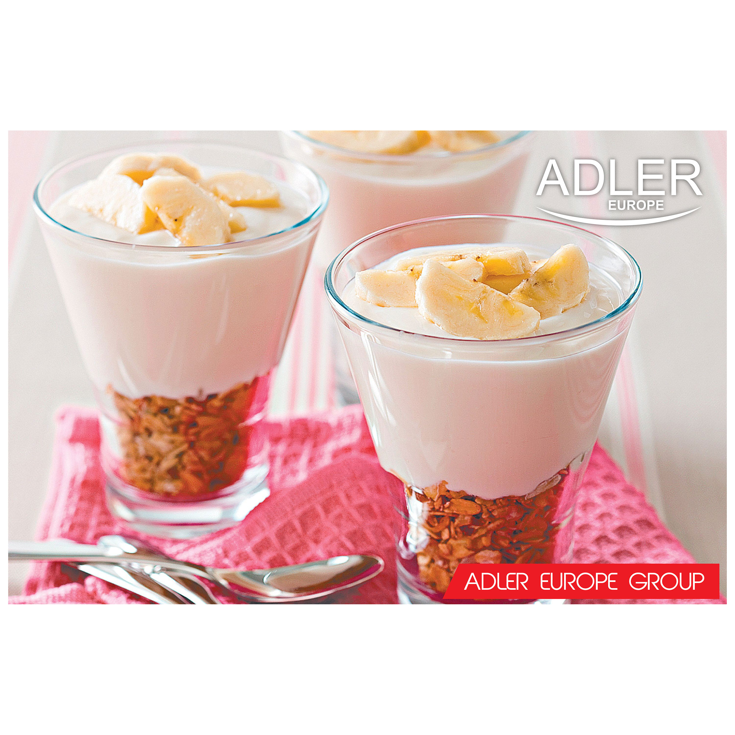 Trzy szklanki jogurtu z granolą i plasterkami banana. Różowa serwetka i rozmyte tło.