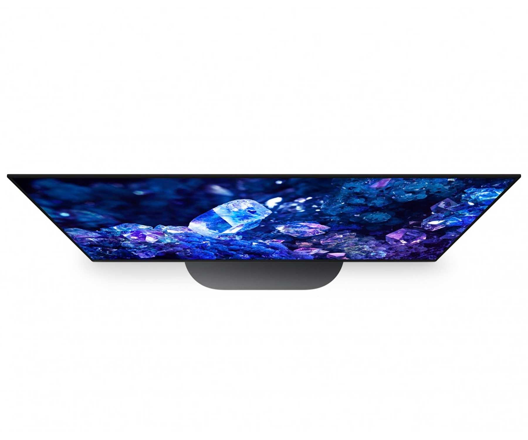 Vista dall'alto di uno schermo TV nero con display vibrante, su sfondo bianco.