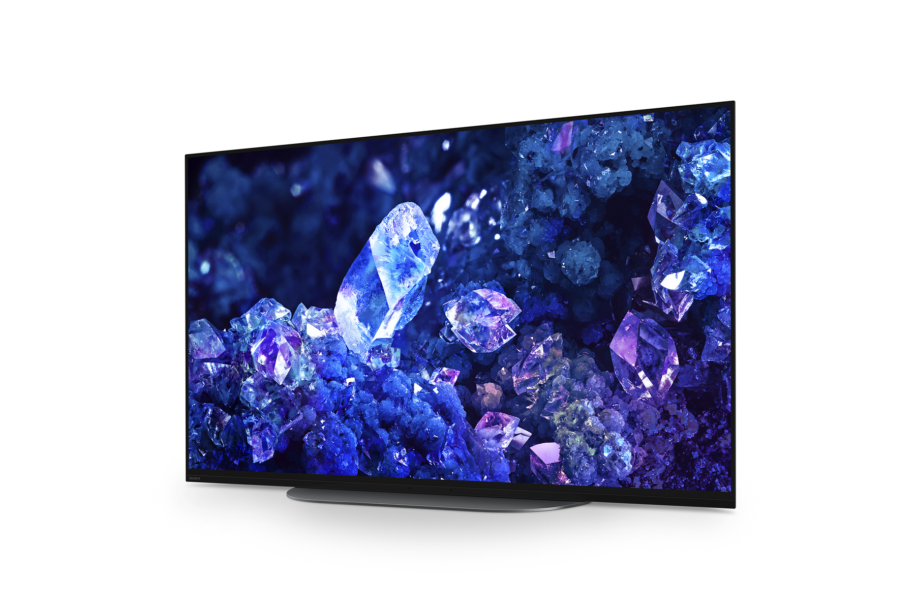 TV a schermo grande con un display astratto colorato. La TV è su un supporto nero.